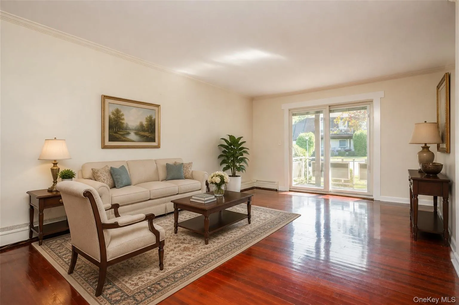 Polished wood-finish flooring, sliding glass doors, white trim, and crown molding, staged photo Polished wood-finish flooring, sliding glass doors, white trim, and crown molding, staged photo