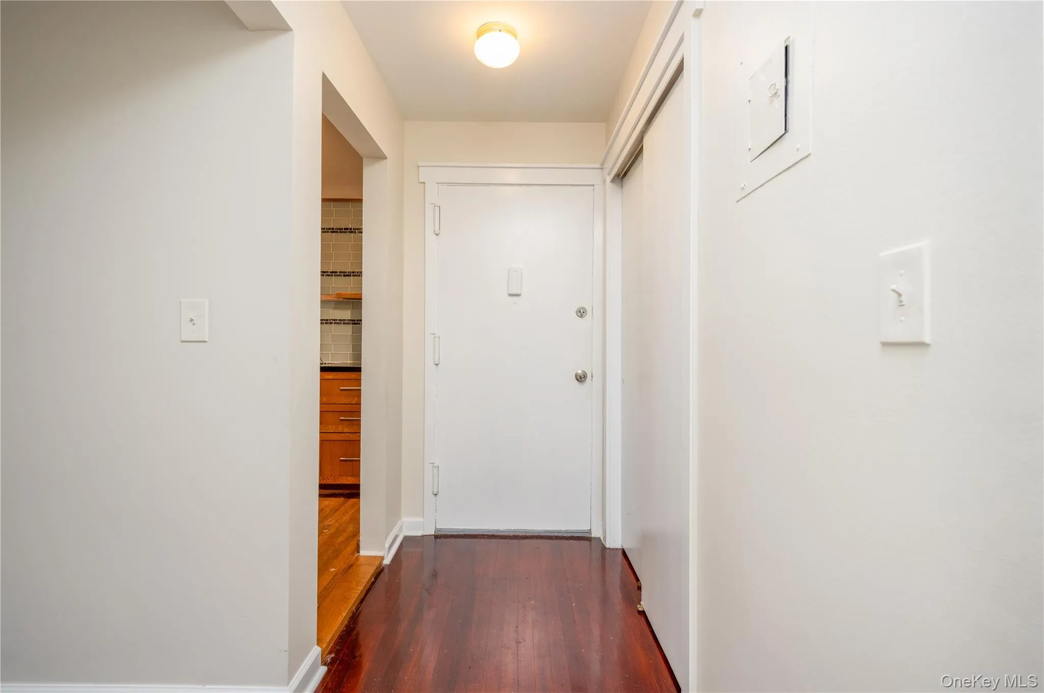 Rich wood-finish flooring extending throughout, white interior walls, and built-in overhead lighting Rich wood-finish flooring extending throughout, white interior walls, and built-in overhead lighting