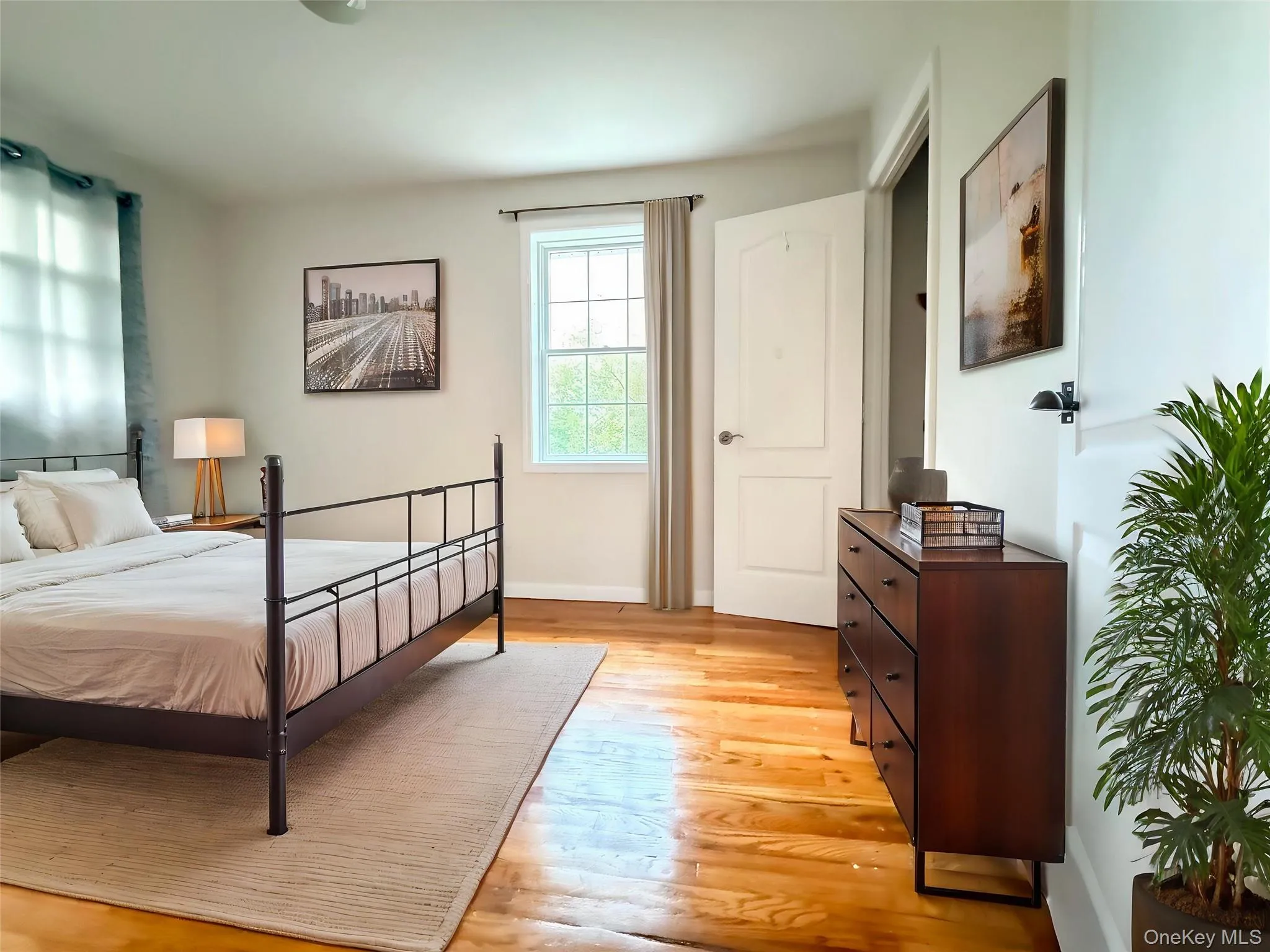 Hardwood flooring, painted walls, white trim, and a built-in closet Hardwood flooring, painted walls, white trim, and a built-in closet