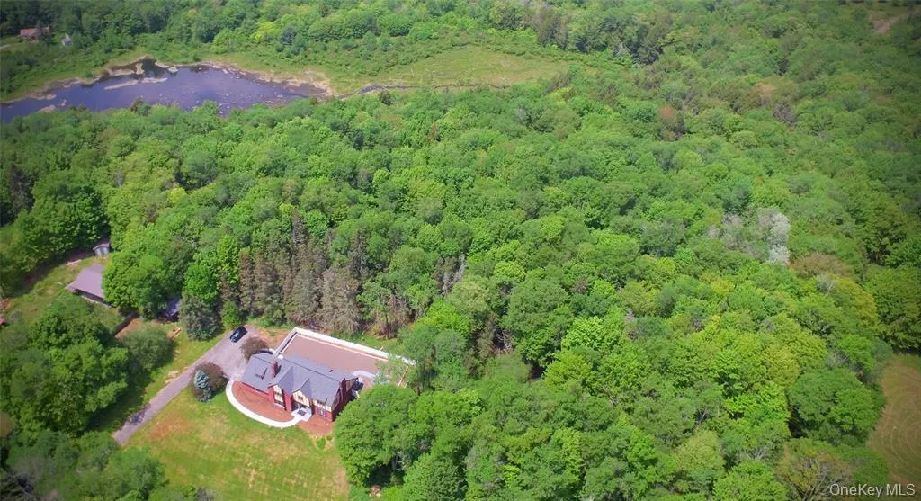 Aerial view of property and surrounding area featuring a forest Aerial view of property and surrounding area featuring a forest