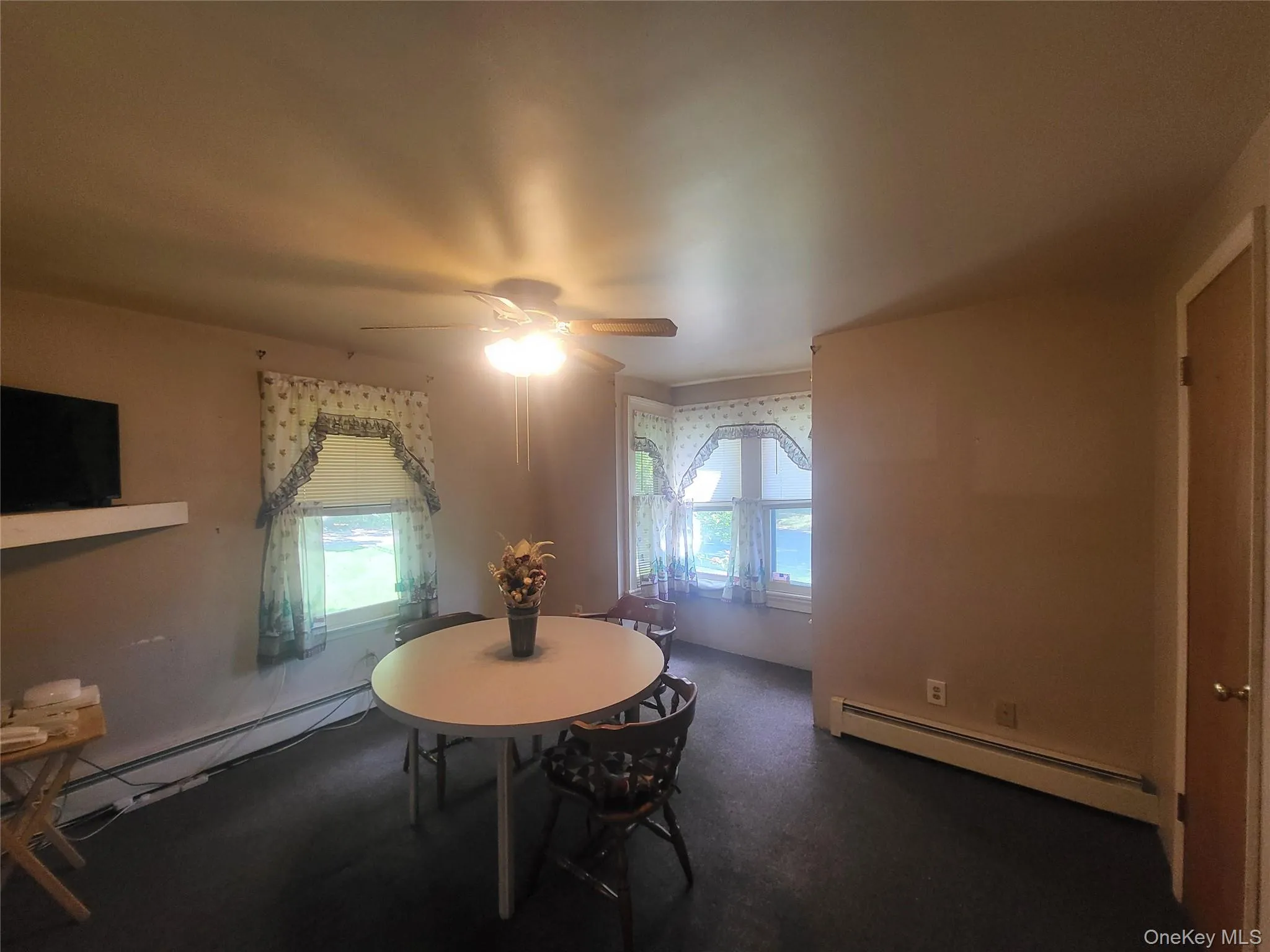 Dining room with bay window adding natural light Dining room with bay window adding natural light