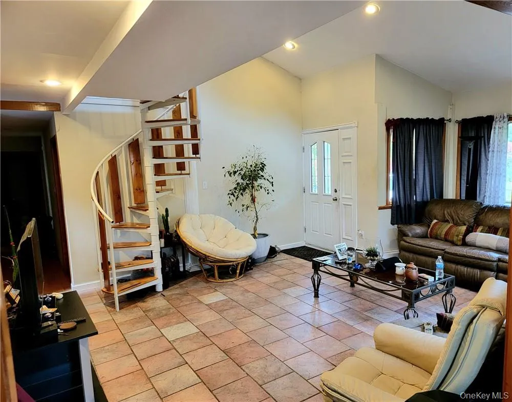 Spacious Foyer with high ceiling and Spiral Stairs Spacious Foyer with high ceiling and Spiral Stairs