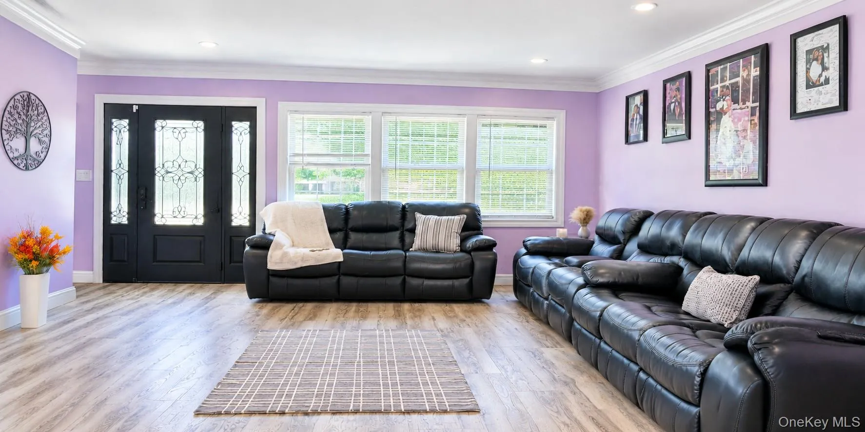 Wood tone -finish flooring, recessed lighting, crown molding, and a decorative front entry door with sidelights. Wood tone -finish flooring, recessed lighting, crown molding, and a decorative front entry door with sidelights.