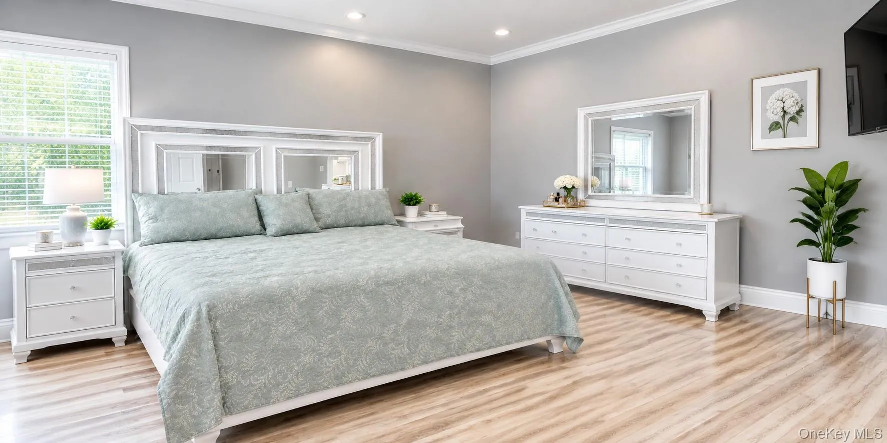 Spacious Bedroom with a new full bath. Neutral wall color, crown molding, new finished flooring, recessed lighting, and a big window Spacious Bedroom with a new full bath. Neutral wall color, crown molding, new finished flooring, recessed lighting, and a big window