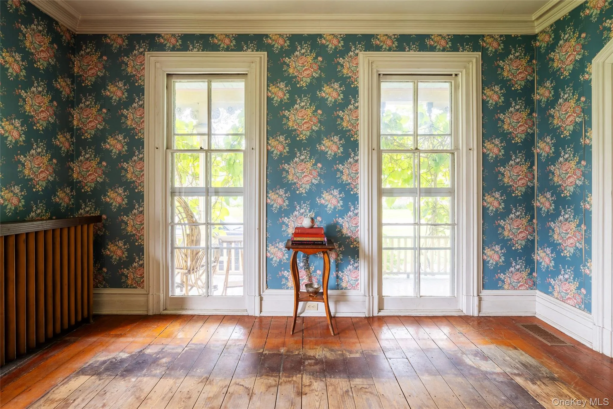 Front parlor with floor to ceiling double-hung windows Front parlor with floor to ceiling double-hung windows