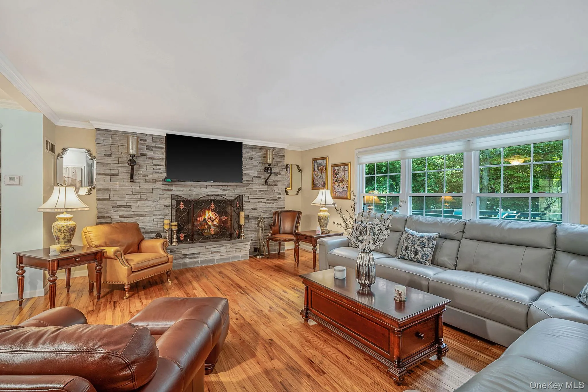 Elegant space with wood floors, wood burning, stone faced fireplace Elegant space with wood floors, wood burning, stone faced fireplace