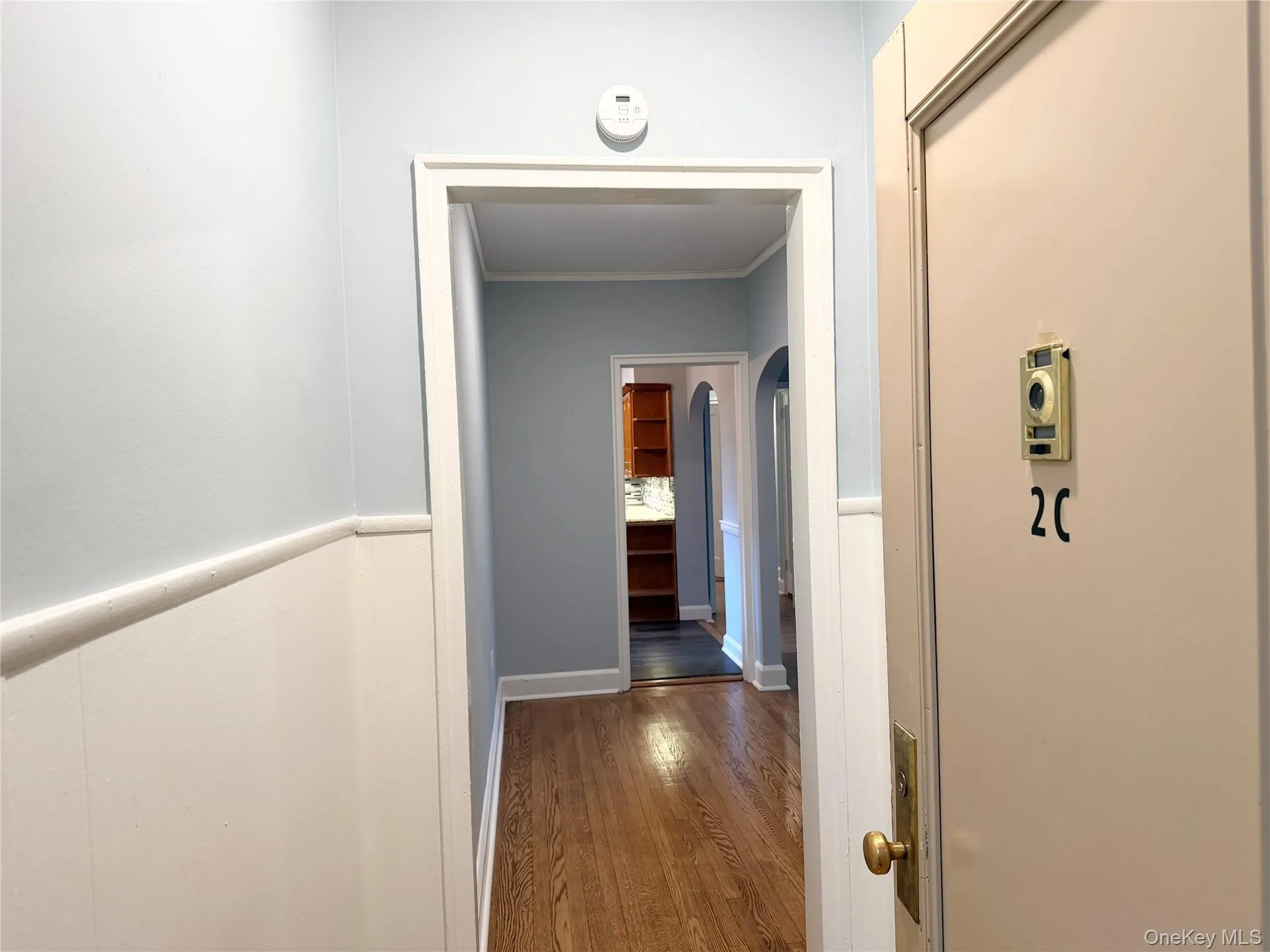 Wood-finish flooring with white wainscoting and light blue walls. Wood-finish flooring with white wainscoting and light blue walls.
