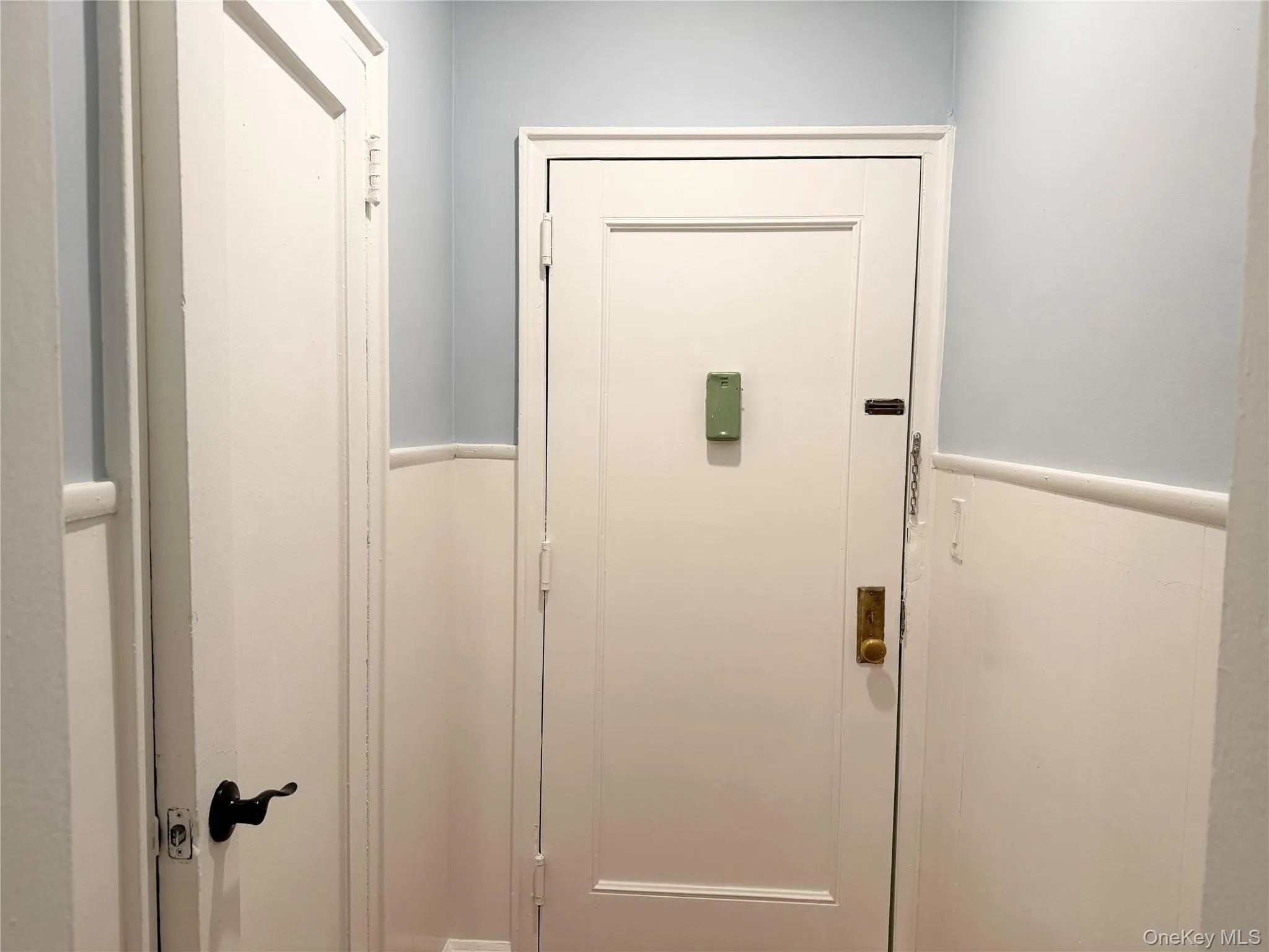 Coat Closet, White painted doors with contrasting hardware. Coat Closet, White painted doors with contrasting hardware.