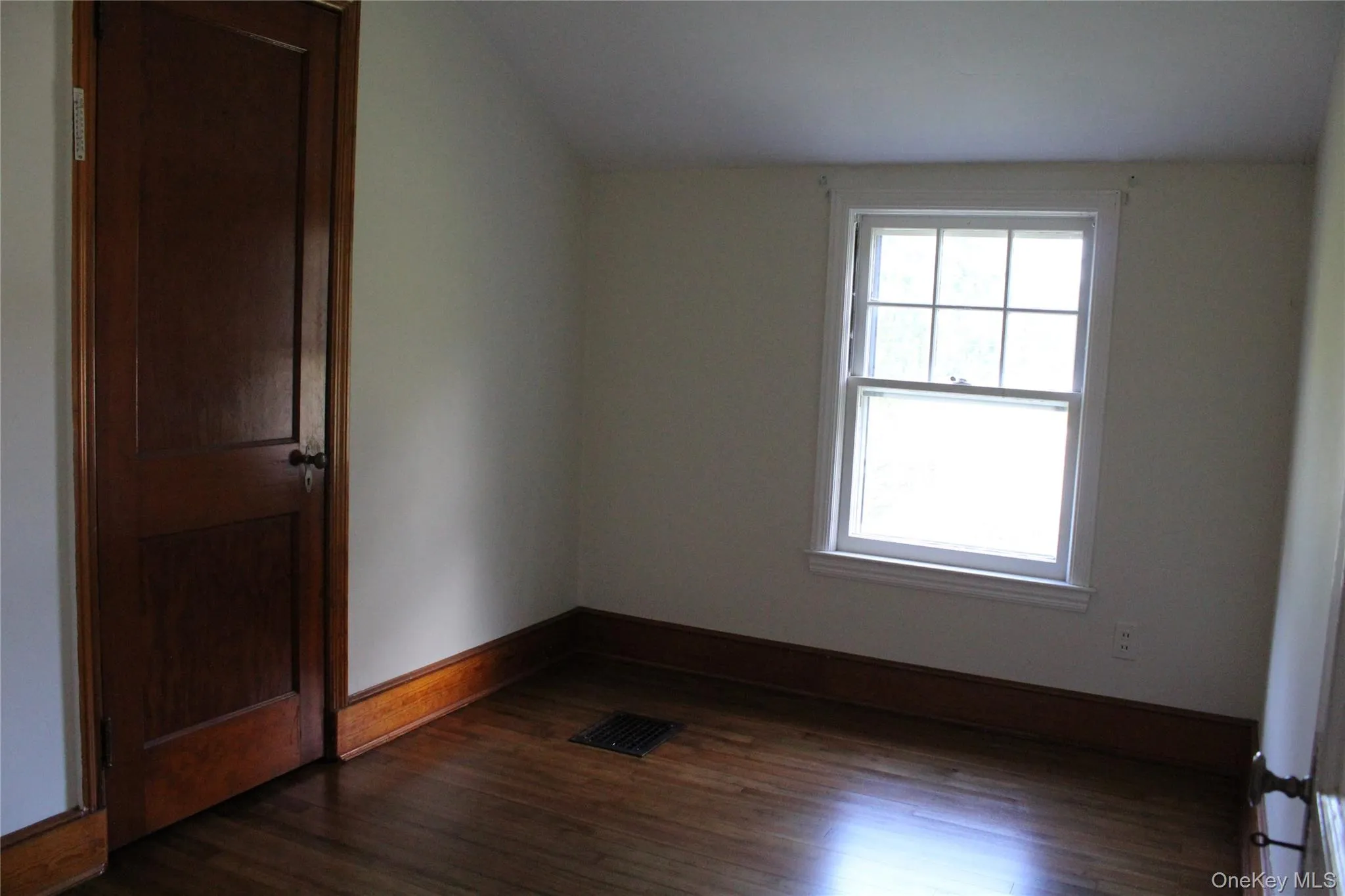 Wood flooring with coordinating wood trim, Walk in closet, and a window Wood flooring with coordinating wood trim, Walk in closet, and a window