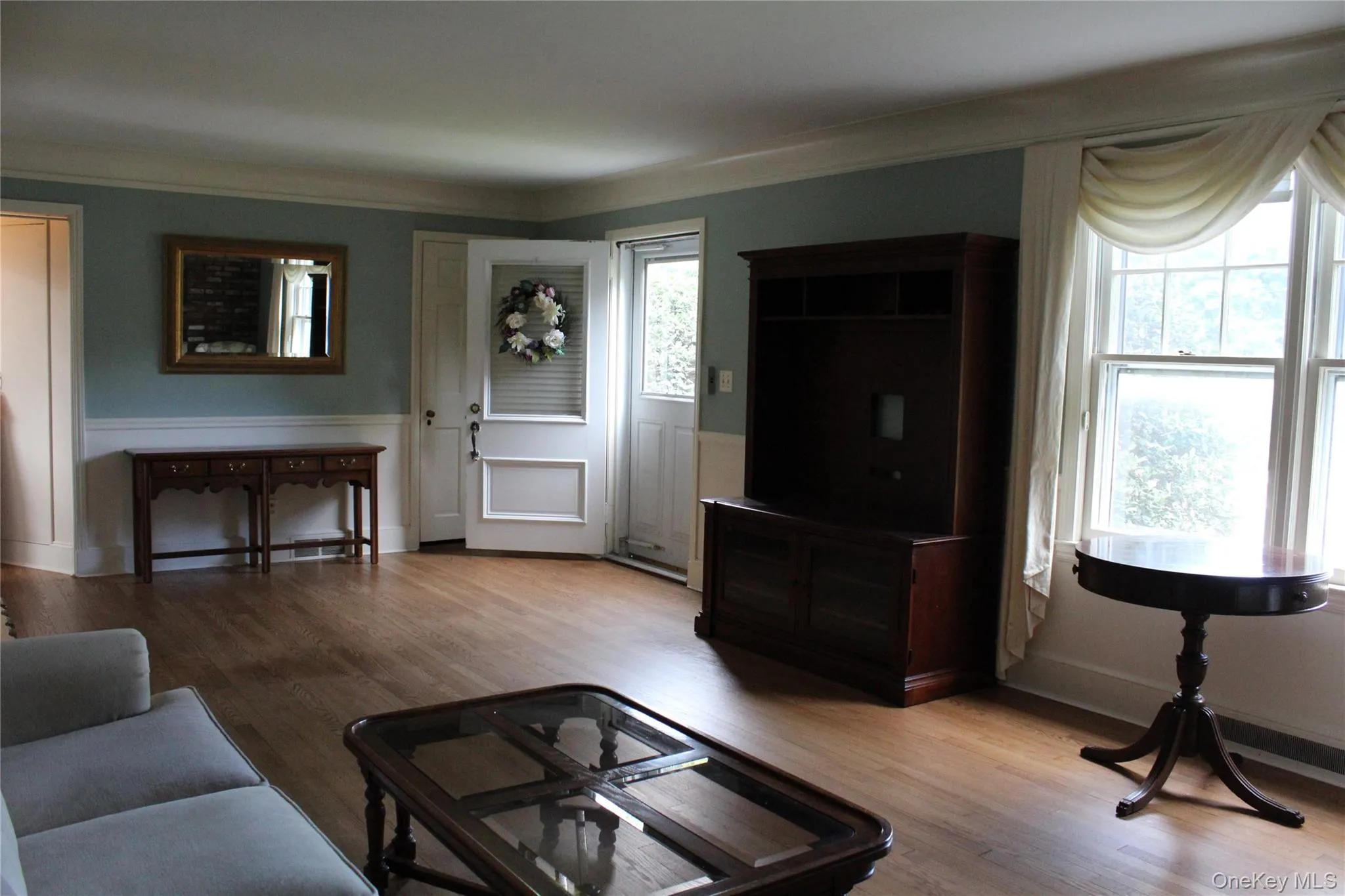 Wood flooring, white paneled wainscoting, and crown molding Wood flooring, white paneled wainscoting, and crown molding
