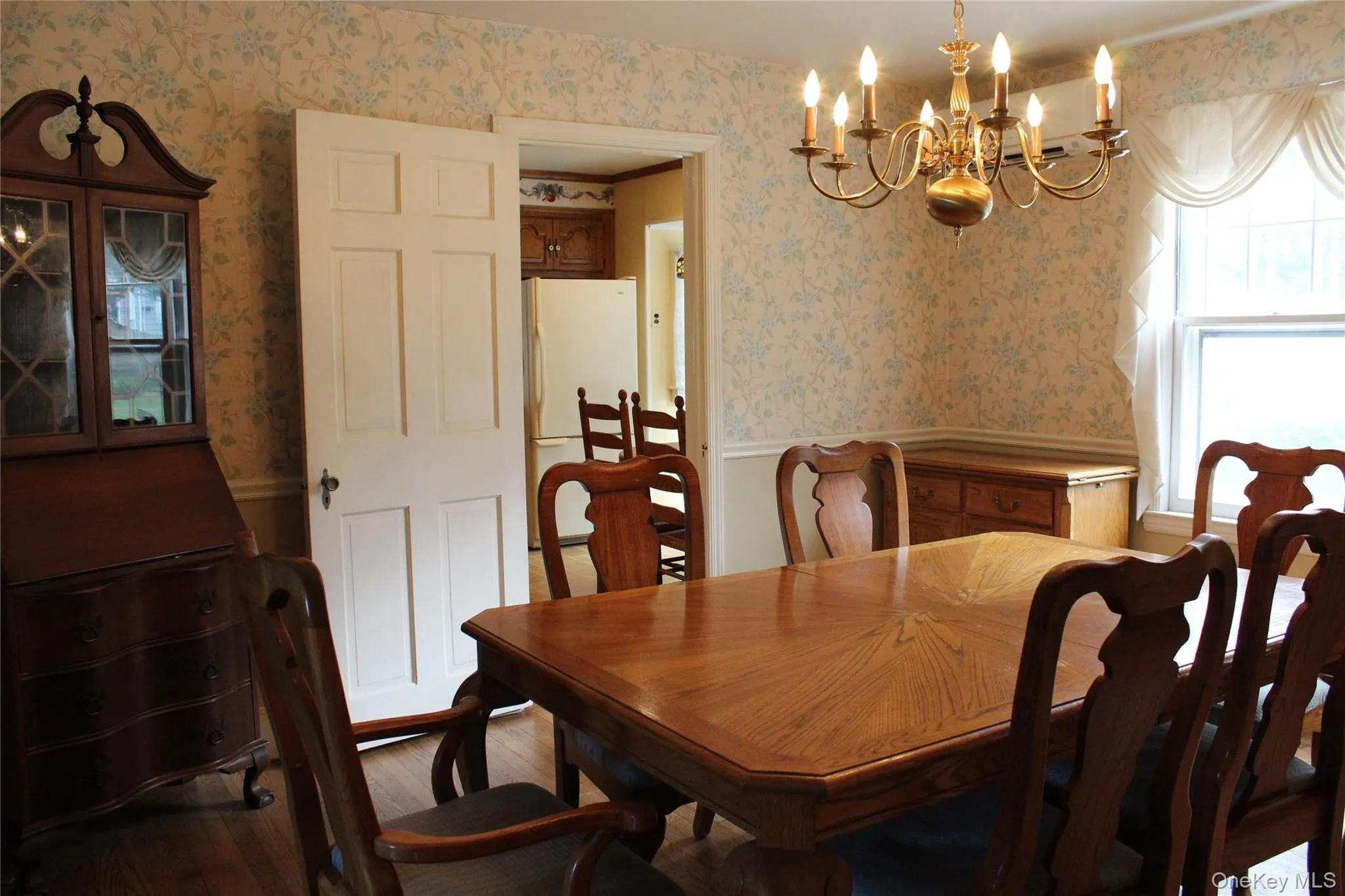 Dining space featuring a brass chandelier and a window. Split AC unit Dining space featuring a brass chandelier and a window. Split AC unit