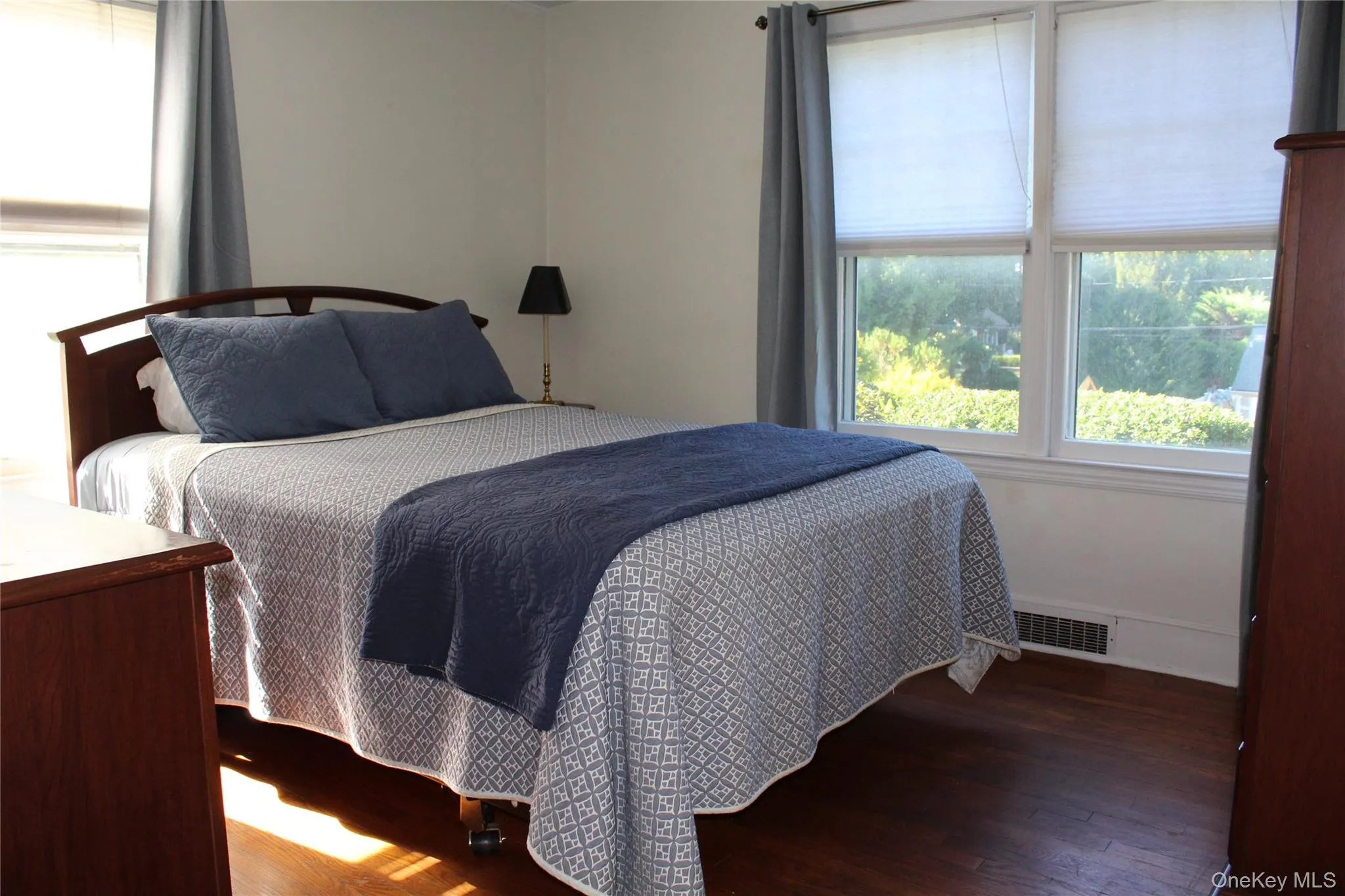 Hardwood flooring, painted white walls, white window trim, and large windows Hardwood flooring, painted white walls, white window trim, and large windows