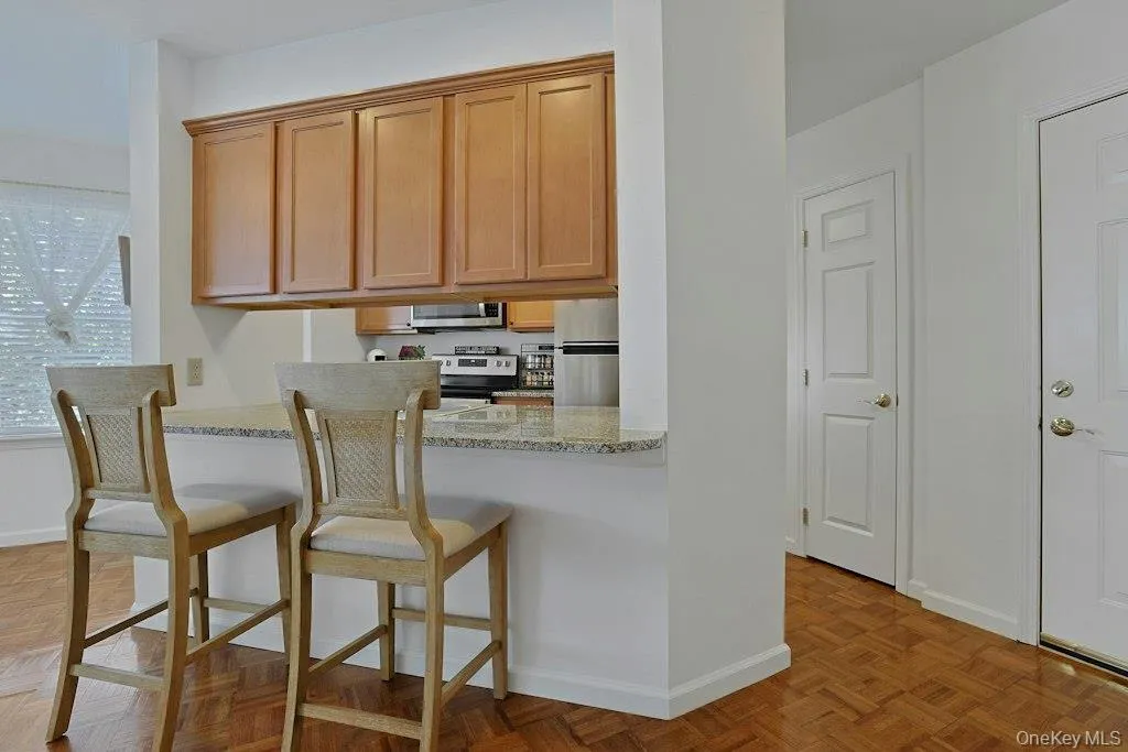 Breakfast Bar with maple cabinetry accessible from both sides. Pantry. Breakfast Bar with maple cabinetry accessible from both sides. Pantry.