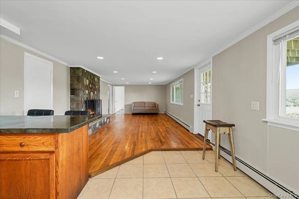 Long shot of kitchen through living room showing entrance. Long shot of kitchen through living room showing entrance.