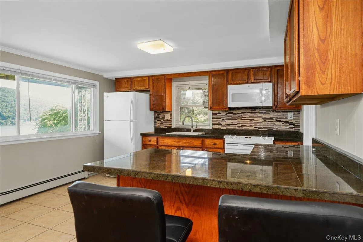 Breakfast bar with marble countertops and lake views. Breakfast bar with marble countertops and lake views.
