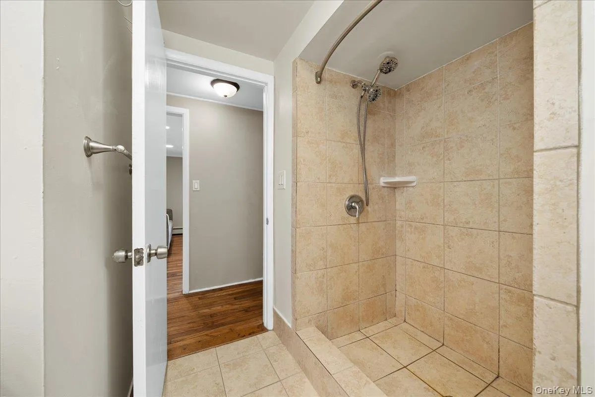 Bathroom featuring large tiled shower. Bathroom featuring large tiled shower.