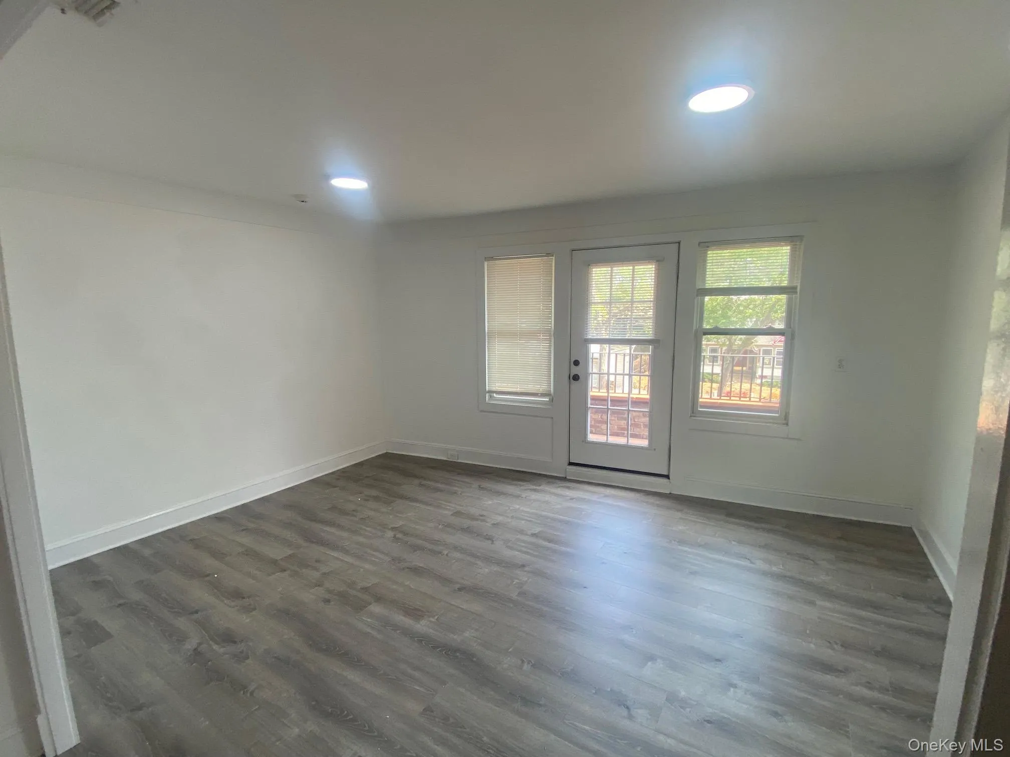 Unfurnished room featuring dark wood-style flooring and recessed lighting Unfurnished room featuring dark wood-style flooring and recessed lighting