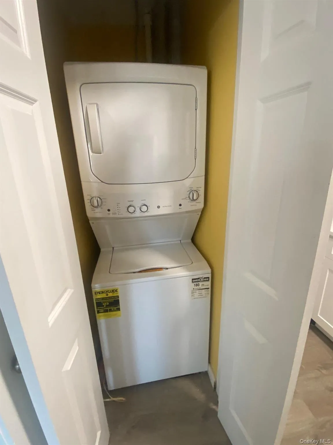 Laundry room featuring stacked washer and clothes dryer Laundry room featuring stacked washer and clothes dryer