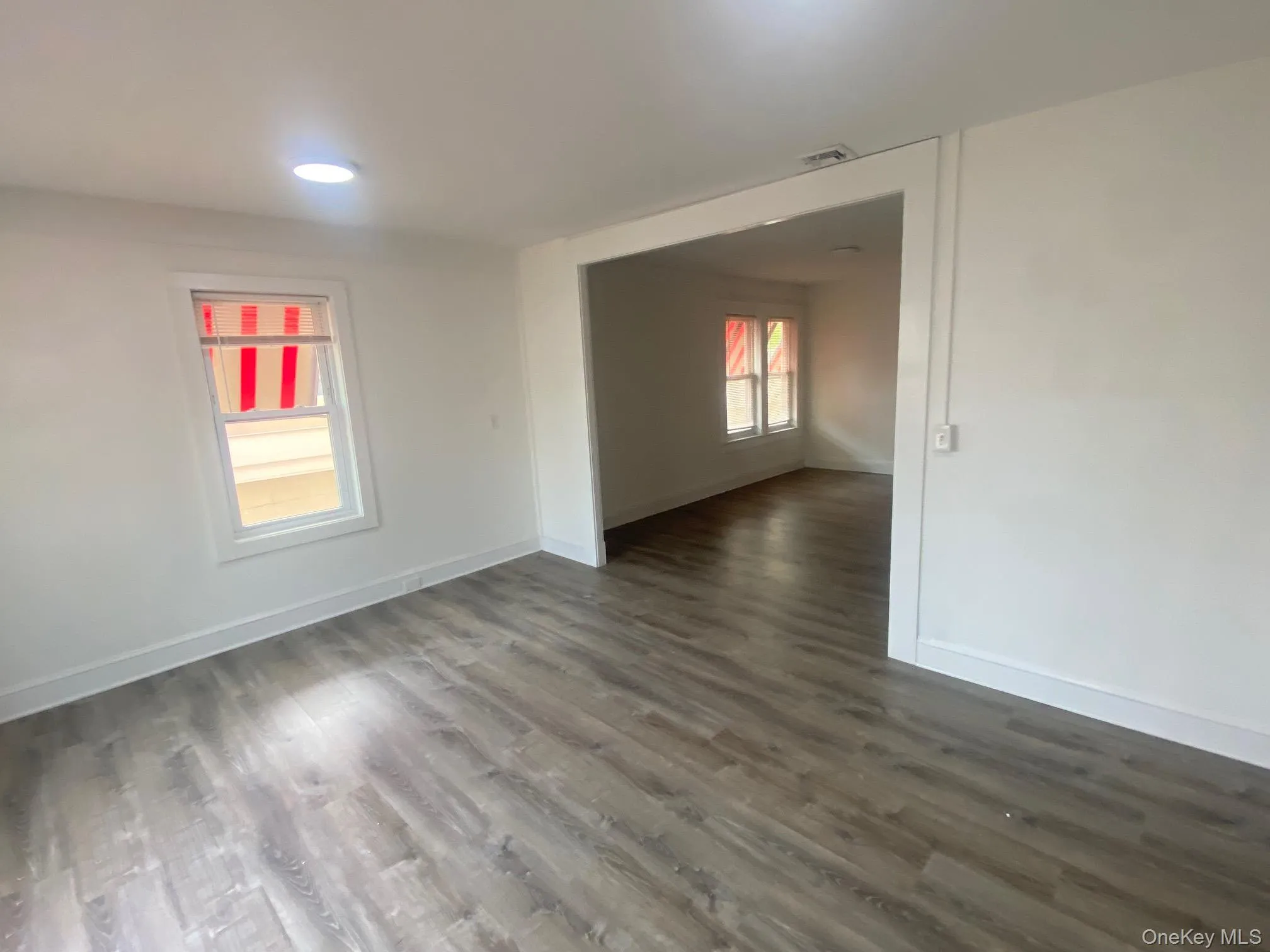 Spare room with dark wood-type flooring Spare room with dark wood-type flooring