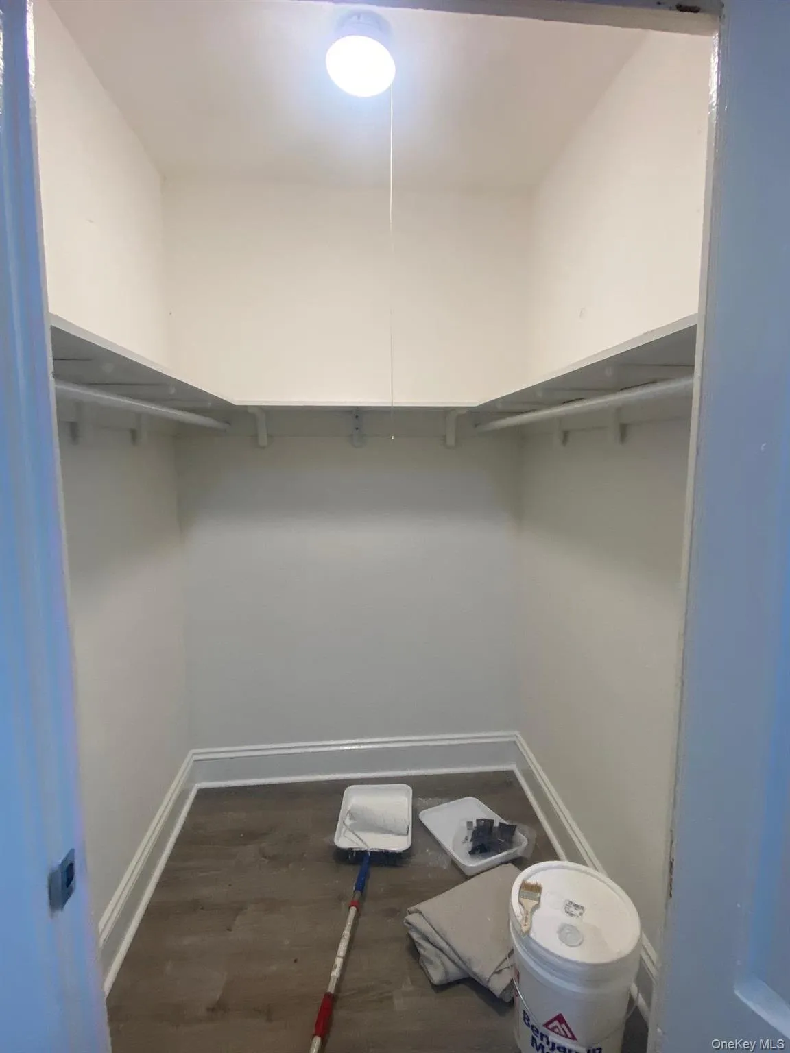 Walk in closet with dark wood finished floors Walk in closet with dark wood finished floors