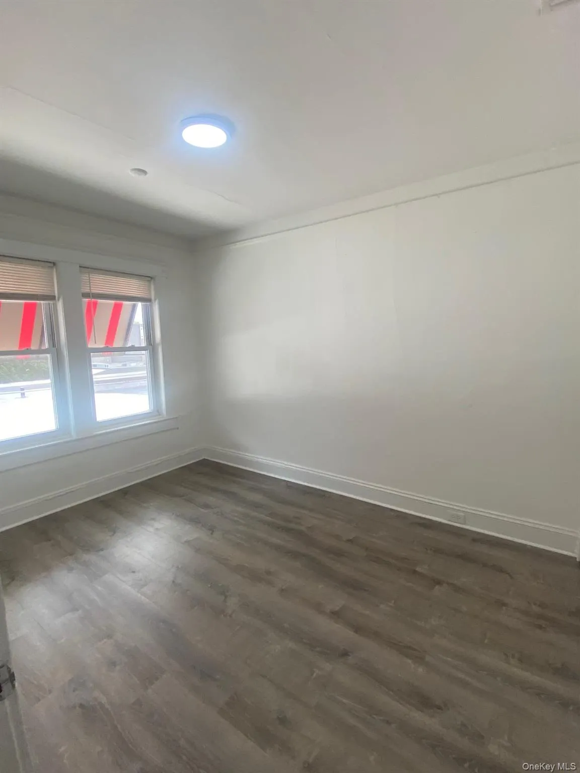 Empty room with dark wood-style flooring Empty room with dark wood-style flooring