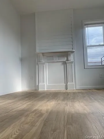 Unfurnished living room with wood finished floors Unfurnished living room with wood finished floors