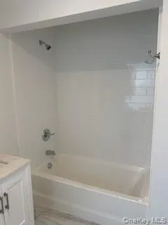 Bathroom with bathing tub / shower combination and vanity Bathroom with bathing tub / shower combination and vanity