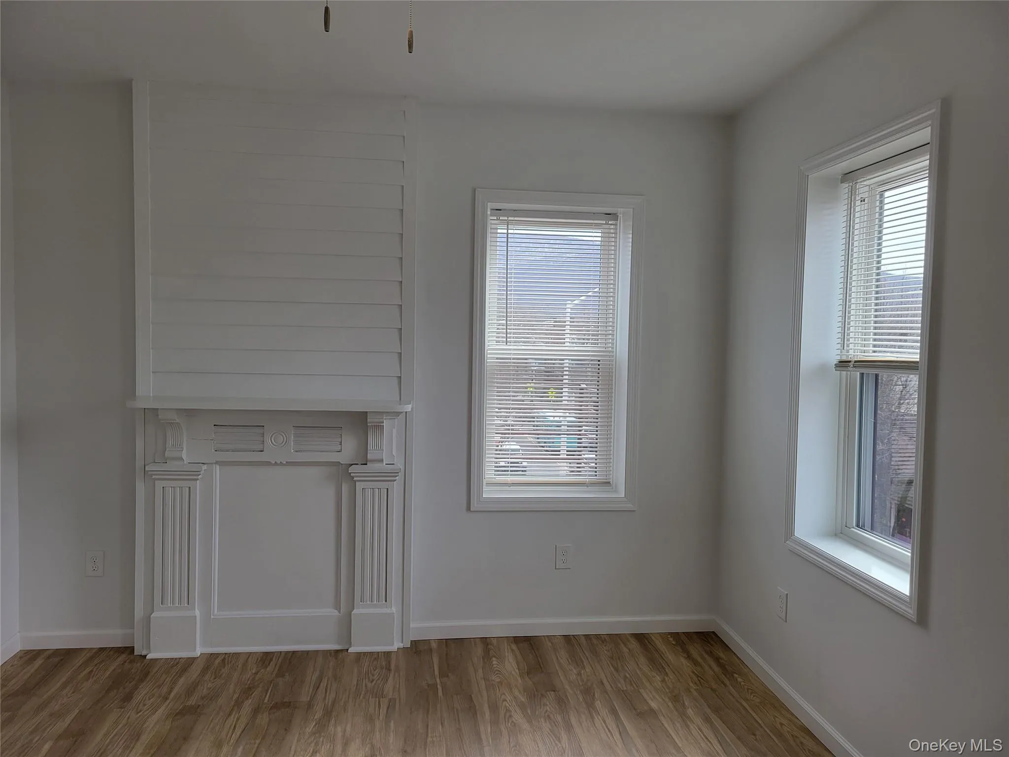 Unfurnished dining area featuring wood finished floors and baseboards Unfurnished dining area featuring wood finished floors and baseboards