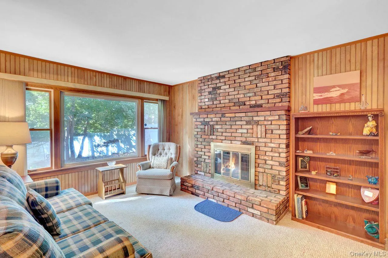 Brick fireplace with hearth, and a large window over looking the yard. Brick fireplace with hearth, and a large window over looking the yard.