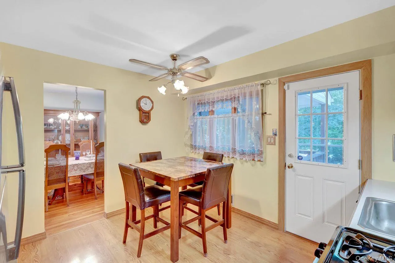 Wood-finish flooring throughout, with a ceiling fan light fixture Wood-finish flooring throughout, with a ceiling fan light fixture