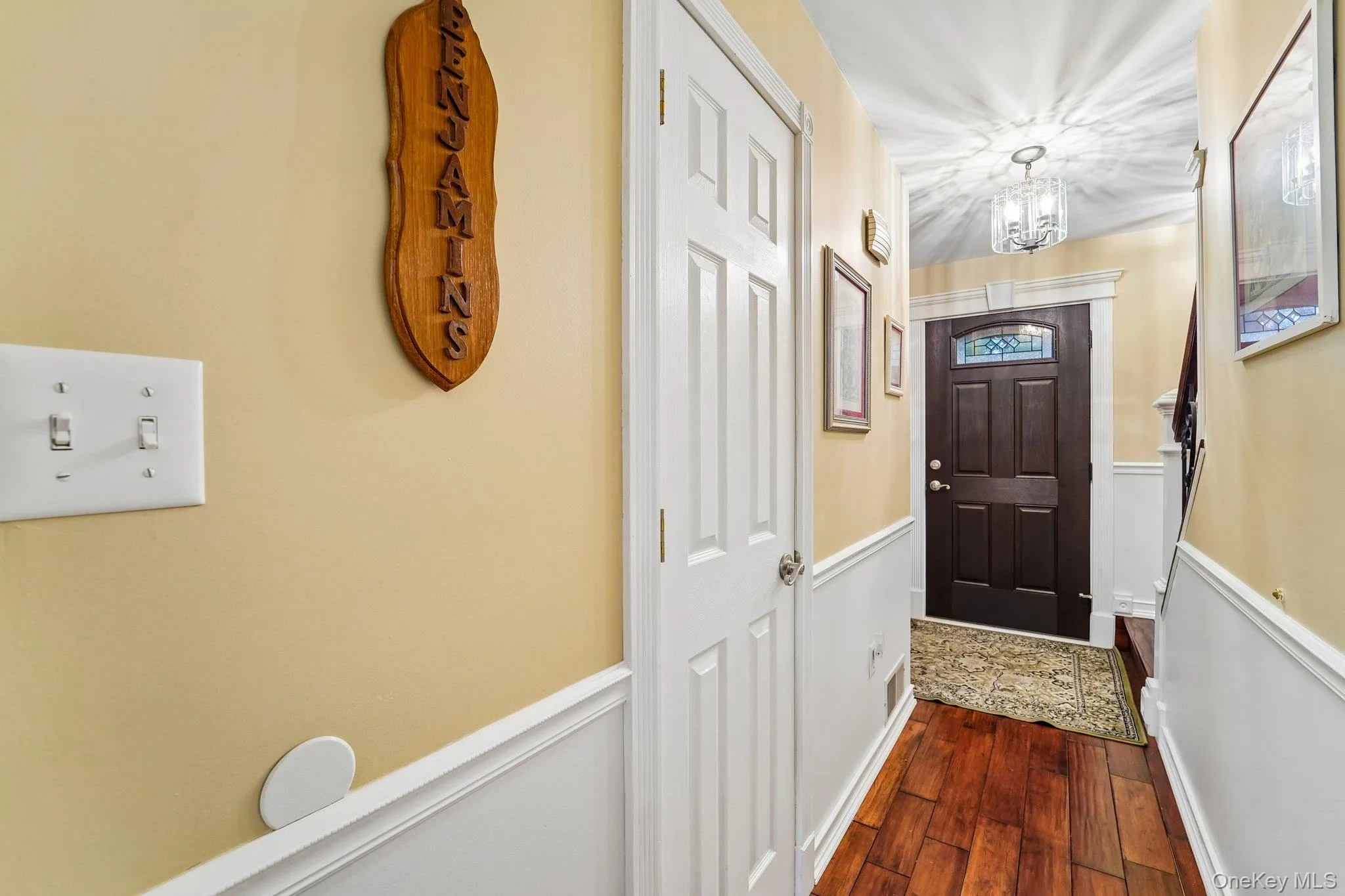 Custom front door - foyer with wainscoting trim Custom front door - foyer with wainscoting trim