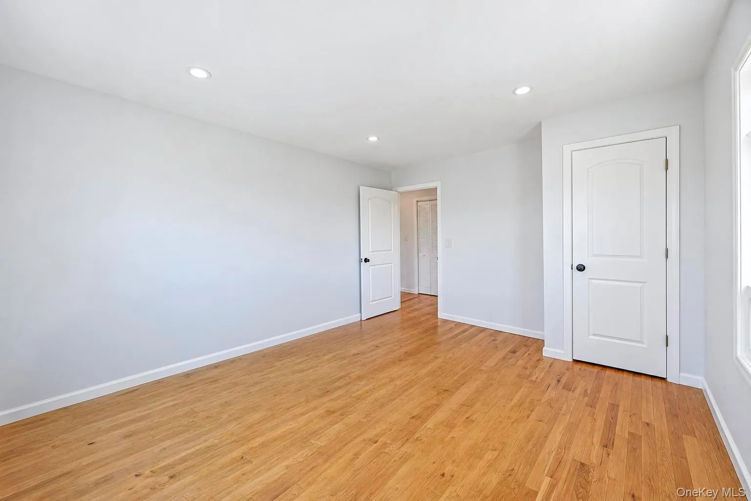 Wood-finish flooring, recessed lighting, and crisp white trim Wood-finish flooring, recessed lighting, and crisp white trim