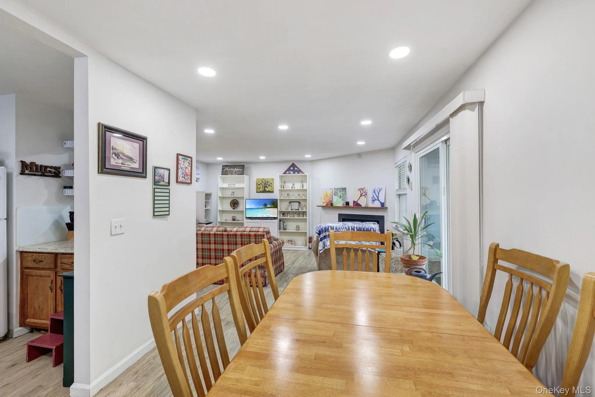 Recessed lighting, wood-finish flooring, sliding glass door, built-in shelving, fireplace Recessed lighting, wood-finish flooring, sliding glass door, built-in shelving, fireplace
