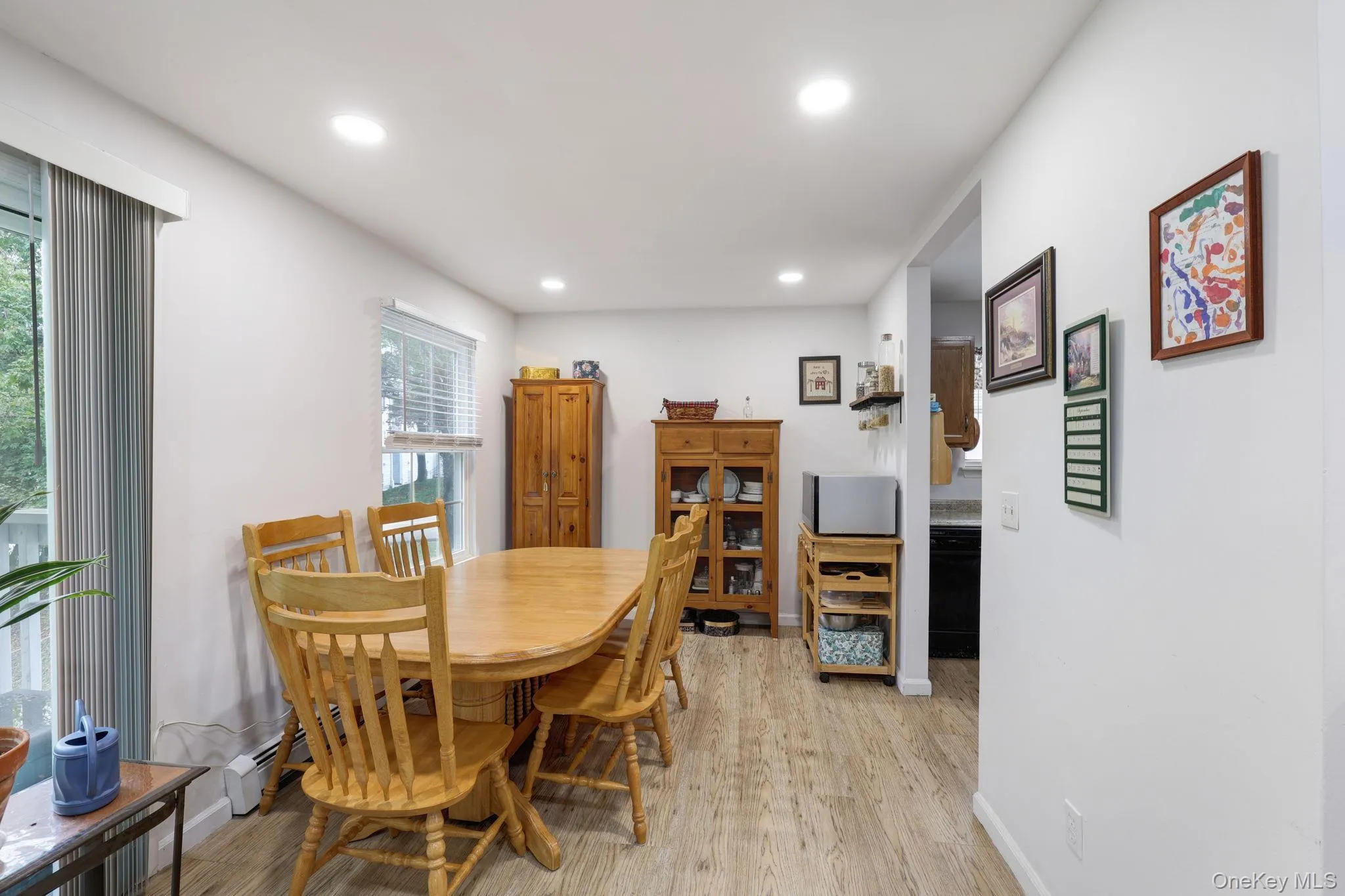 Recessed lighting illuminates the wood-finish flooring and light-toned walls Recessed lighting illuminates the wood-finish flooring and light-toned walls