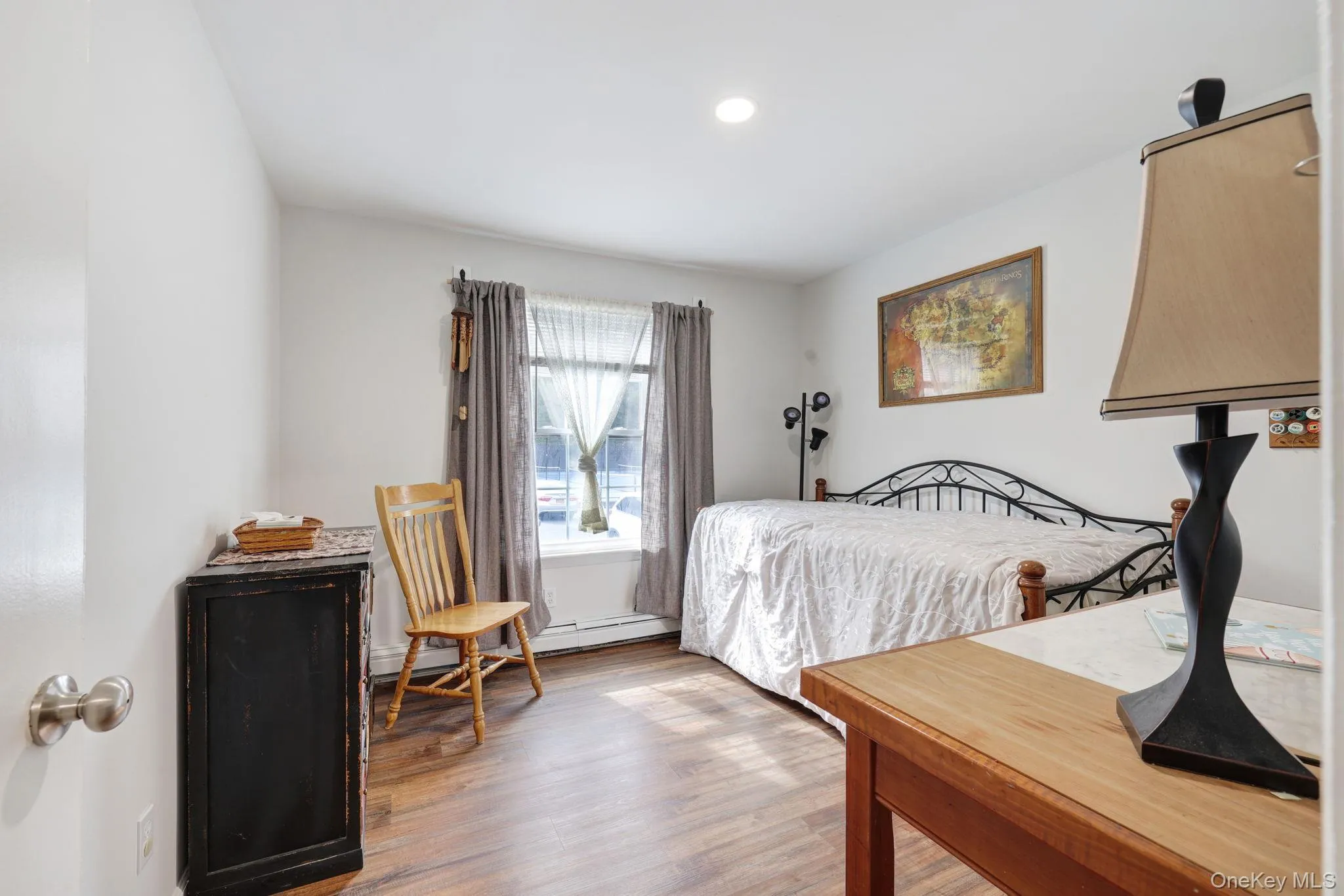 Recessed ceiling light, wood-finish flooring, and white painted walls Recessed ceiling light, wood-finish flooring, and white painted walls