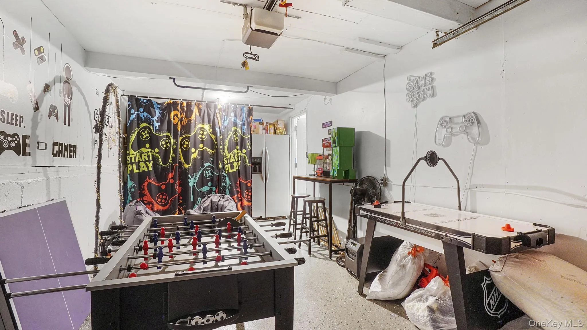 Playroom featuring a garage and speckle patterned floor Playroom featuring a garage and speckle patterned floor