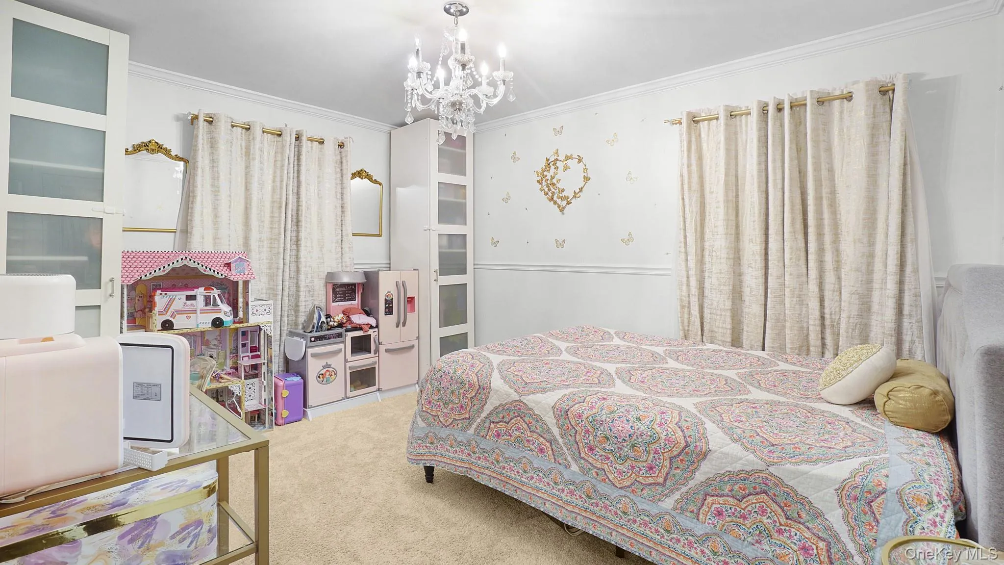 Carpeted bedroom featuring a chandelier and ornamental molding Carpeted bedroom featuring a chandelier and ornamental molding