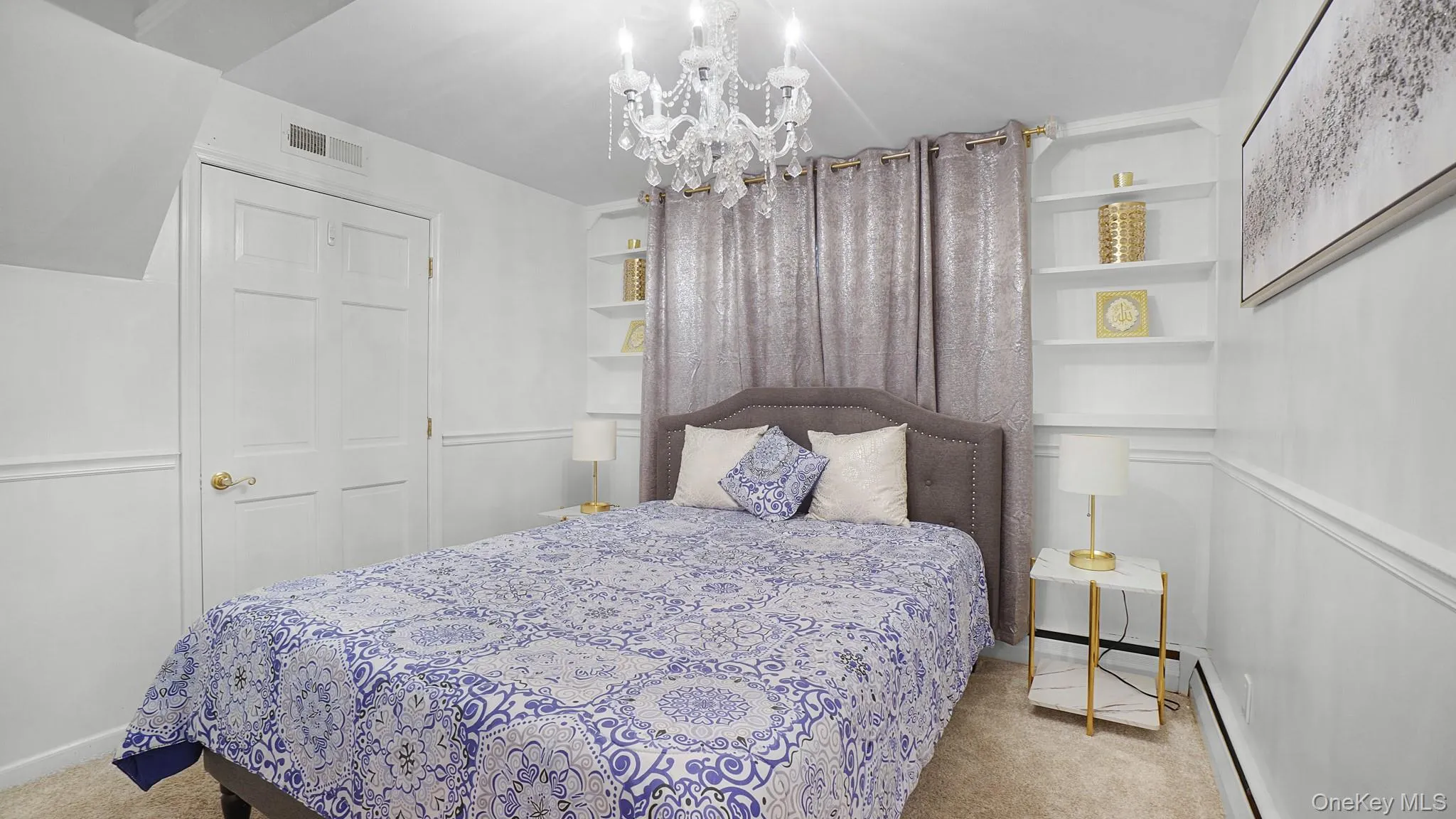 Bedroom with a chandelier, carpet, and a baseboard heating unit Bedroom with a chandelier, carpet, and a baseboard heating unit