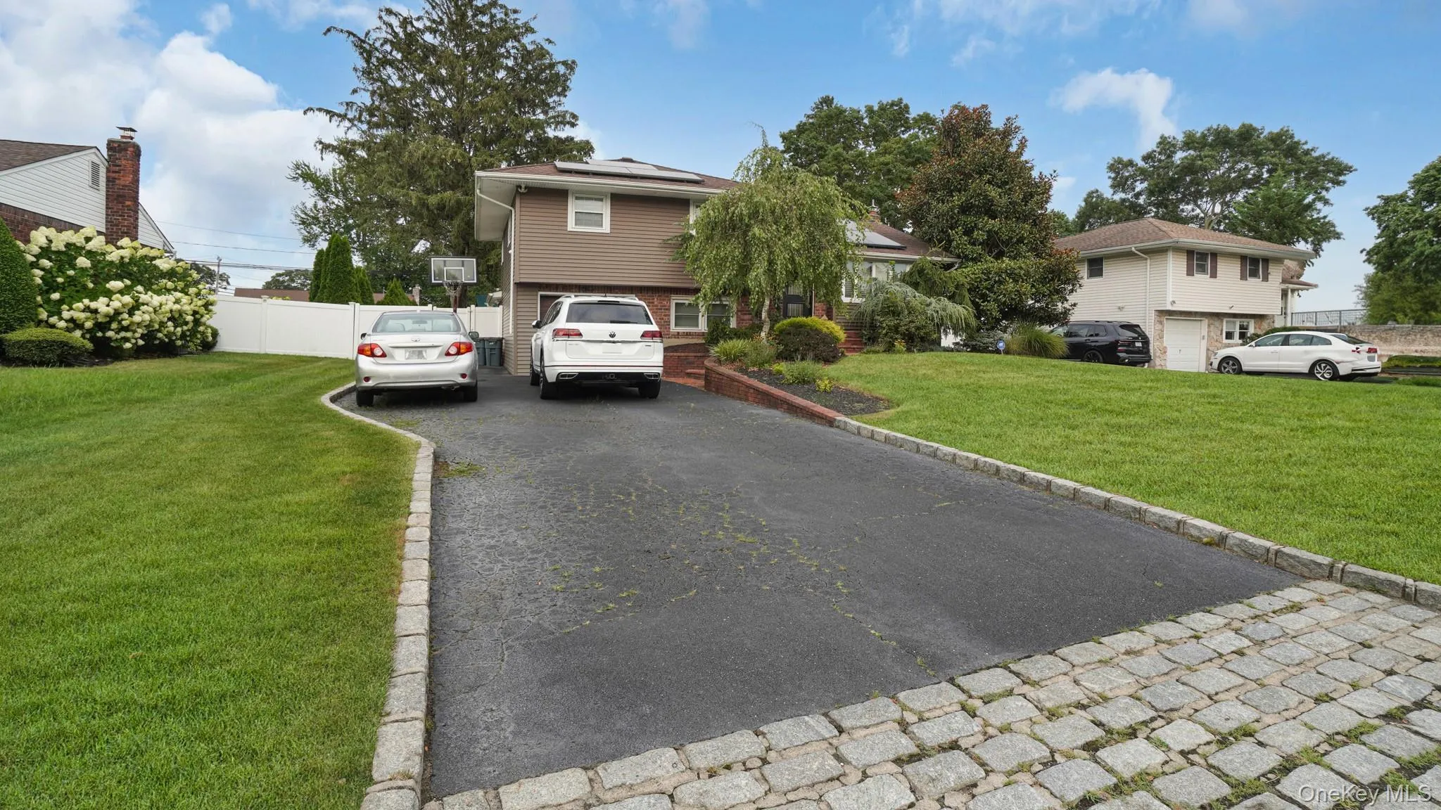 View of front of house with asphalt driveway and solar panels View of front of house with asphalt driveway and solar panels