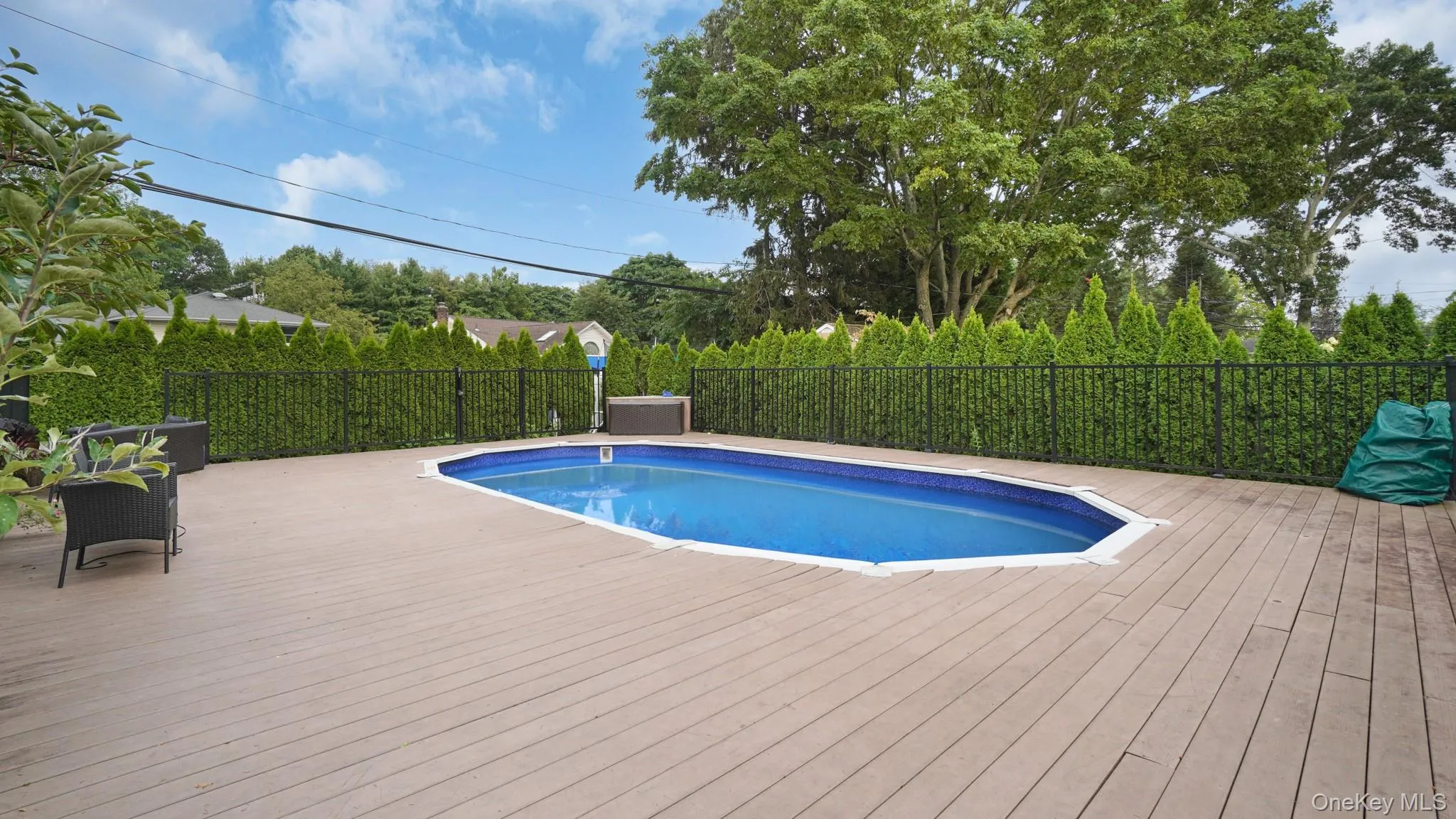 View of pool featuring a wooden deck View of pool featuring a wooden deck