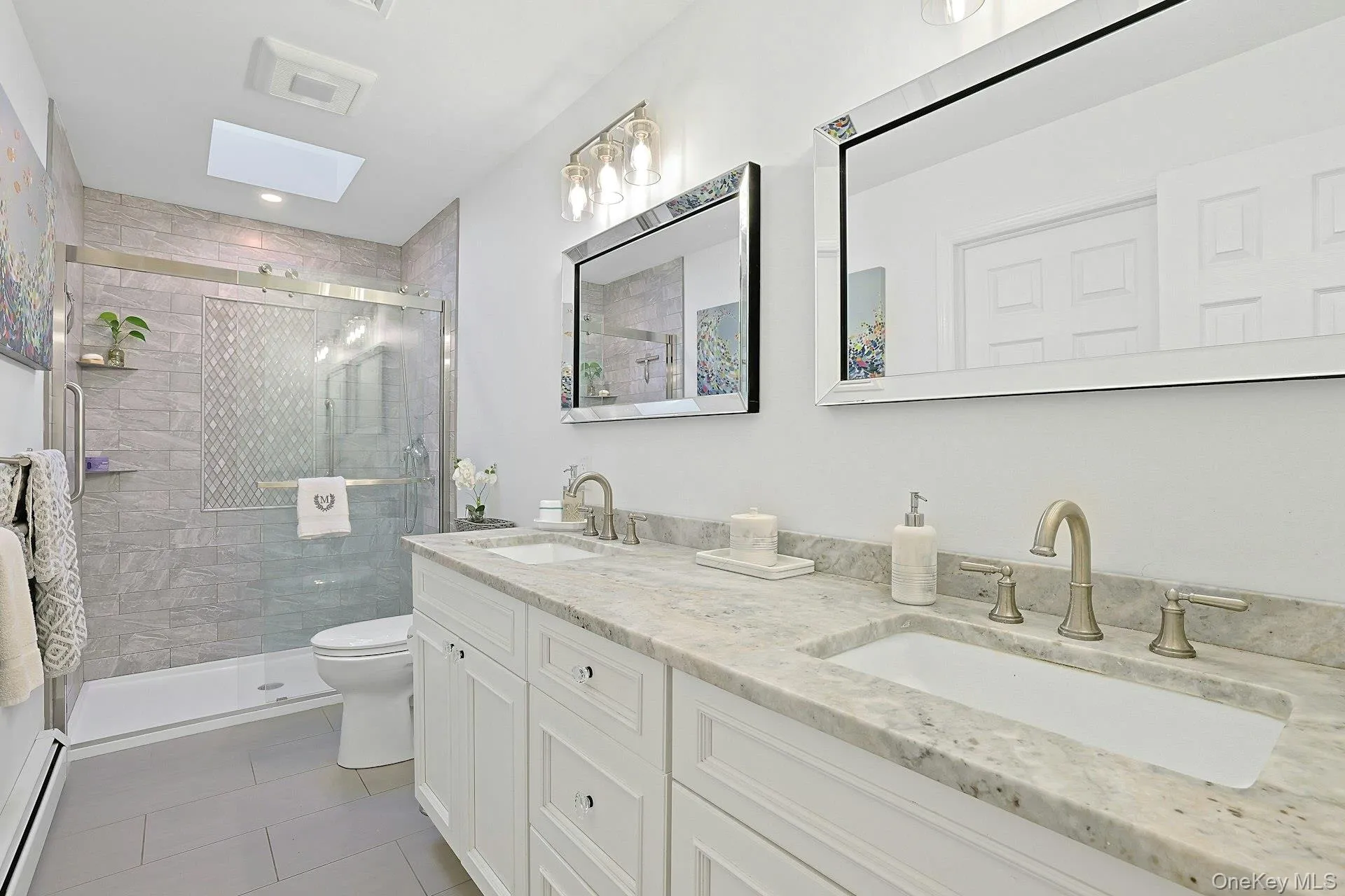 This beautiful bath is on the main floor and dual to the original primary bedroom. It has a large double vanity and walk-in shower. This beautiful bath is on the main floor and dual to the original primary bedroom. It has a large double vanity and walk-in shower.