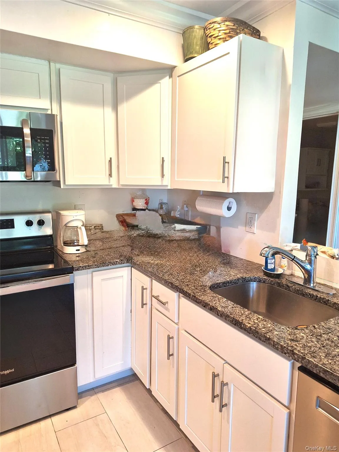 Open concept kitchen with granite countertops and stainless steel appliances. Open concept kitchen with granite countertops and stainless steel appliances.