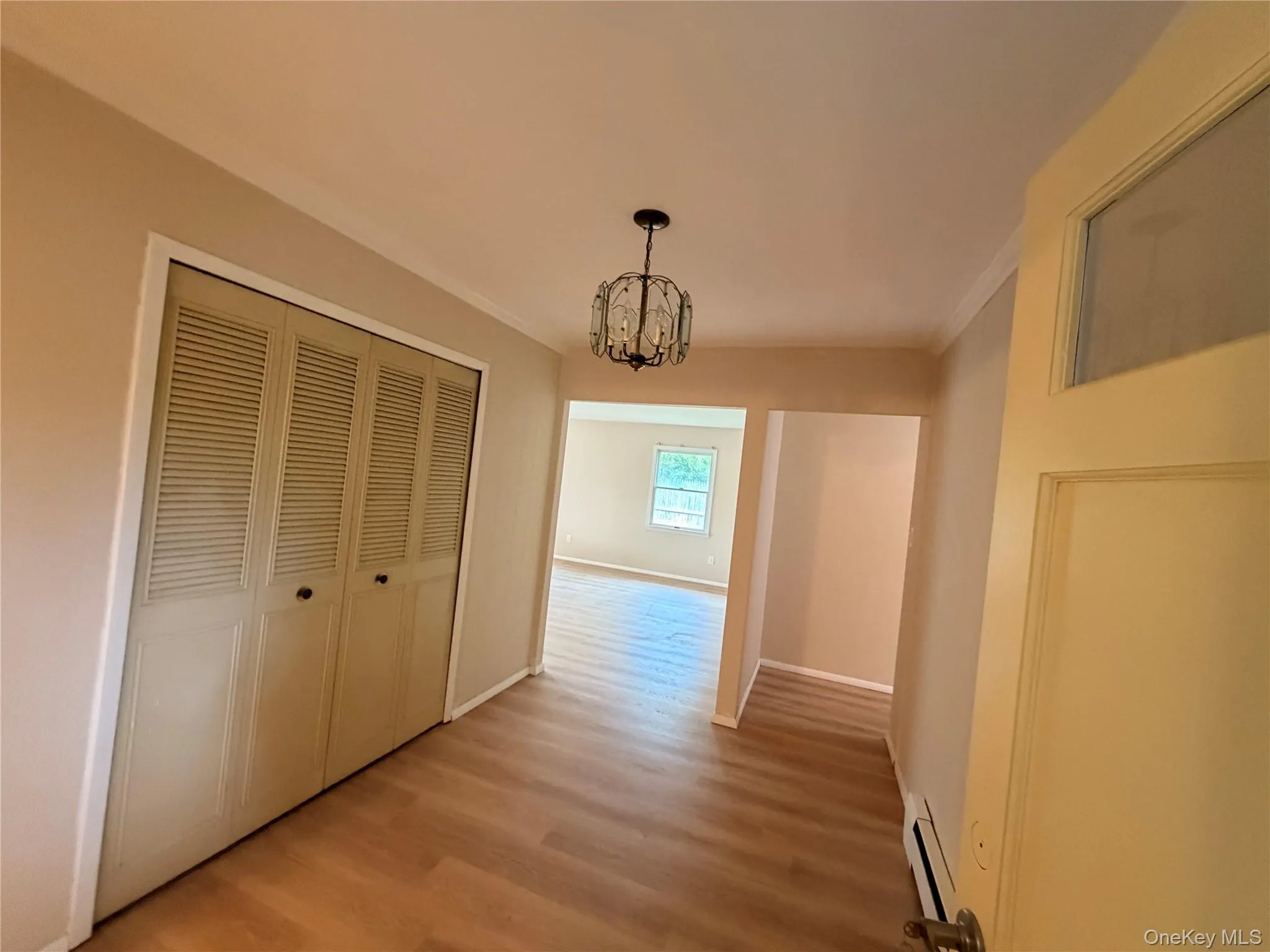 Wood-finish flooring throughout, louvered bi-fold closet doors, and crown molding Wood-finish flooring throughout, louvered bi-fold closet doors, and crown molding