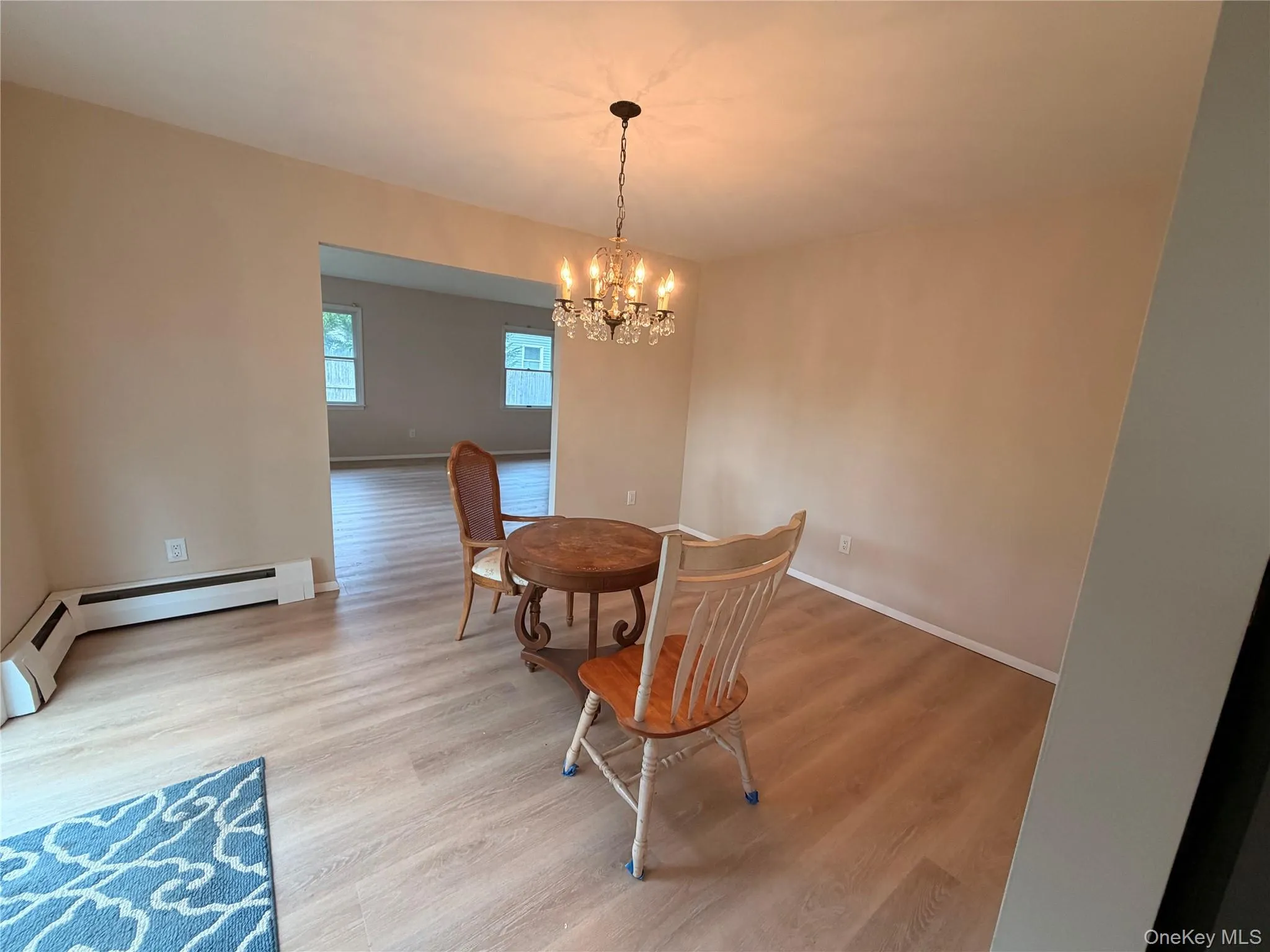 Recessed lighting, wood-finish flooring, and a chandelier with crystal-look accents Recessed lighting, wood-finish flooring, and a chandelier with crystal-look accents