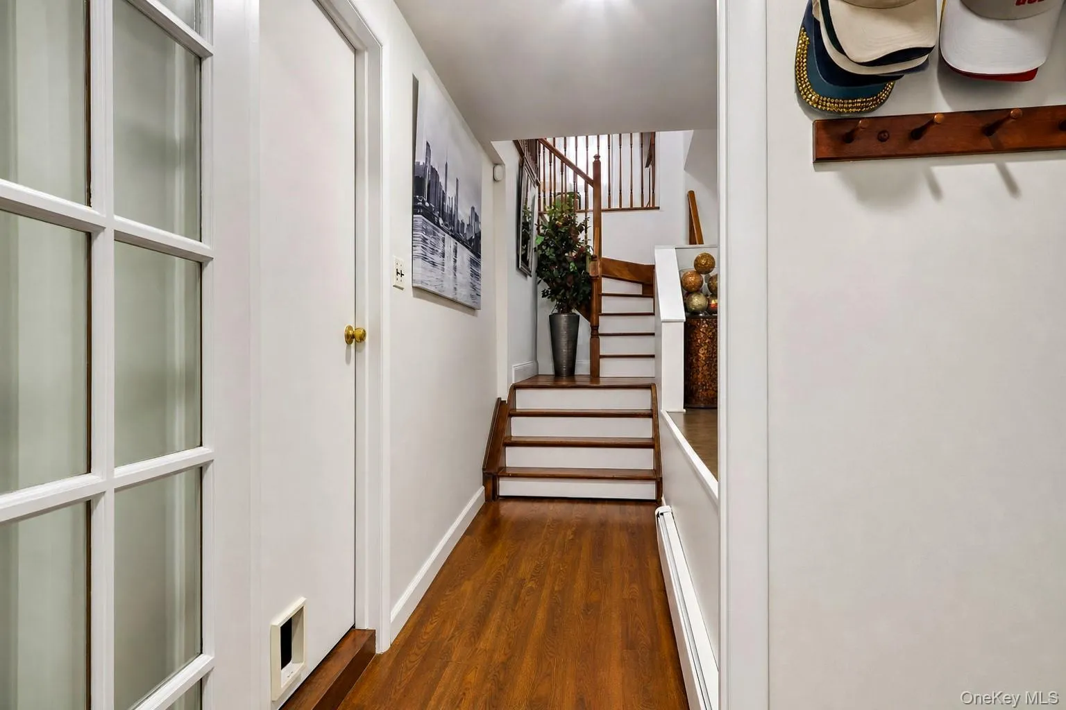 Entry hallway with access to laundry room and full storage room~ Entry hallway with access to laundry room and full storage room~
