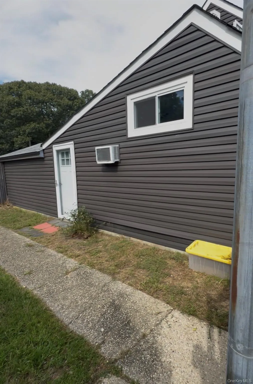 Dark-toned horizontal siding with white trim Dark-toned horizontal siding with white trim