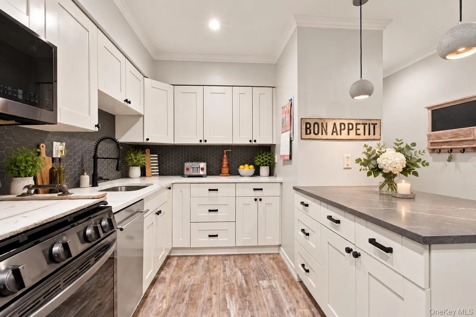 Spacious kitchen with an extended countertop offering ample workspace and seating for casual dining and entertaining. Spacious kitchen with an extended countertop offering ample workspace and seating for casual dining and entertaining.