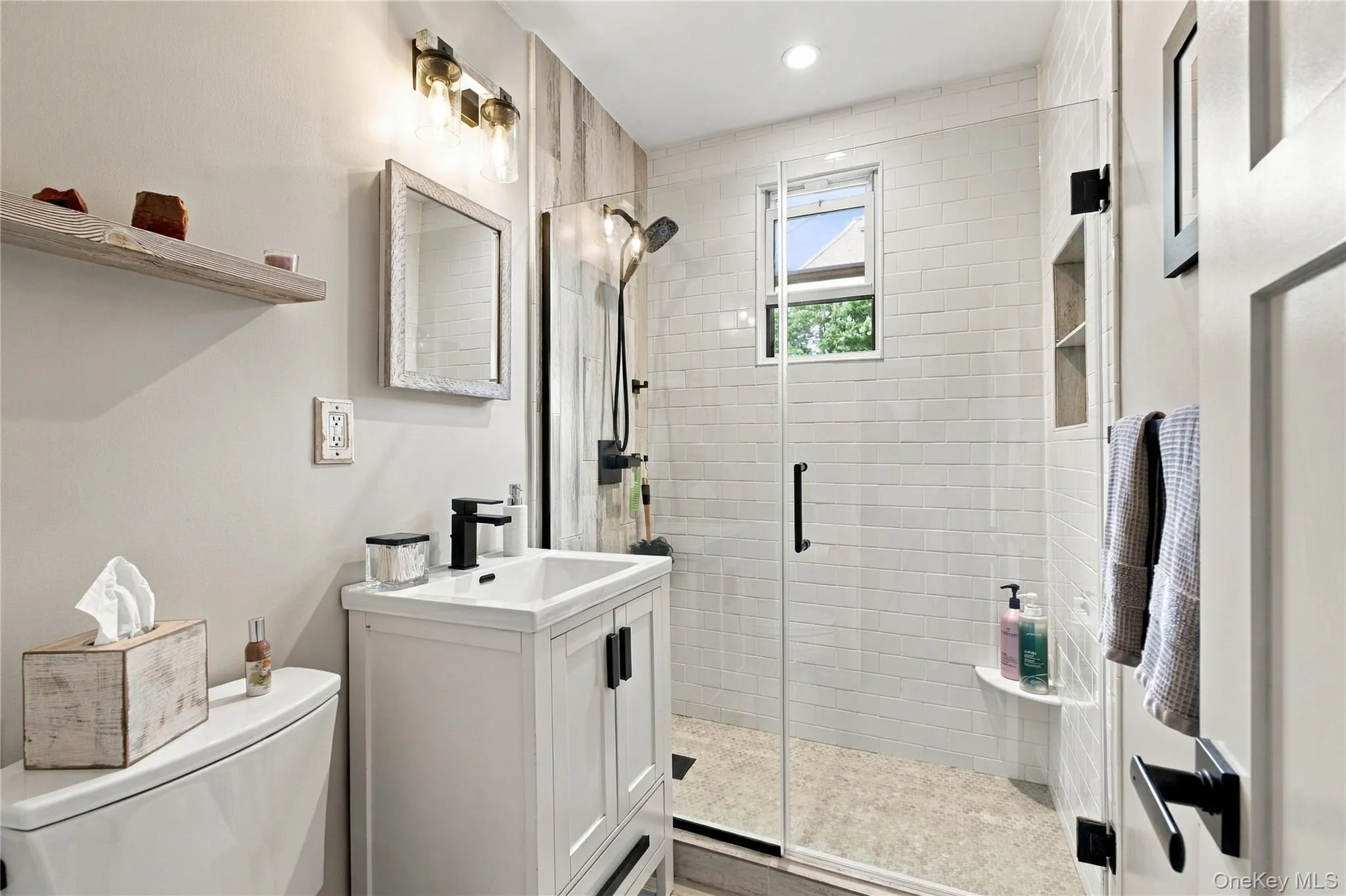 The fully renovated bathroom showcases a sleek design, highlighted by a large shower and contemporary details. The fully renovated bathroom showcases a sleek design, highlighted by a large shower and contemporary details.