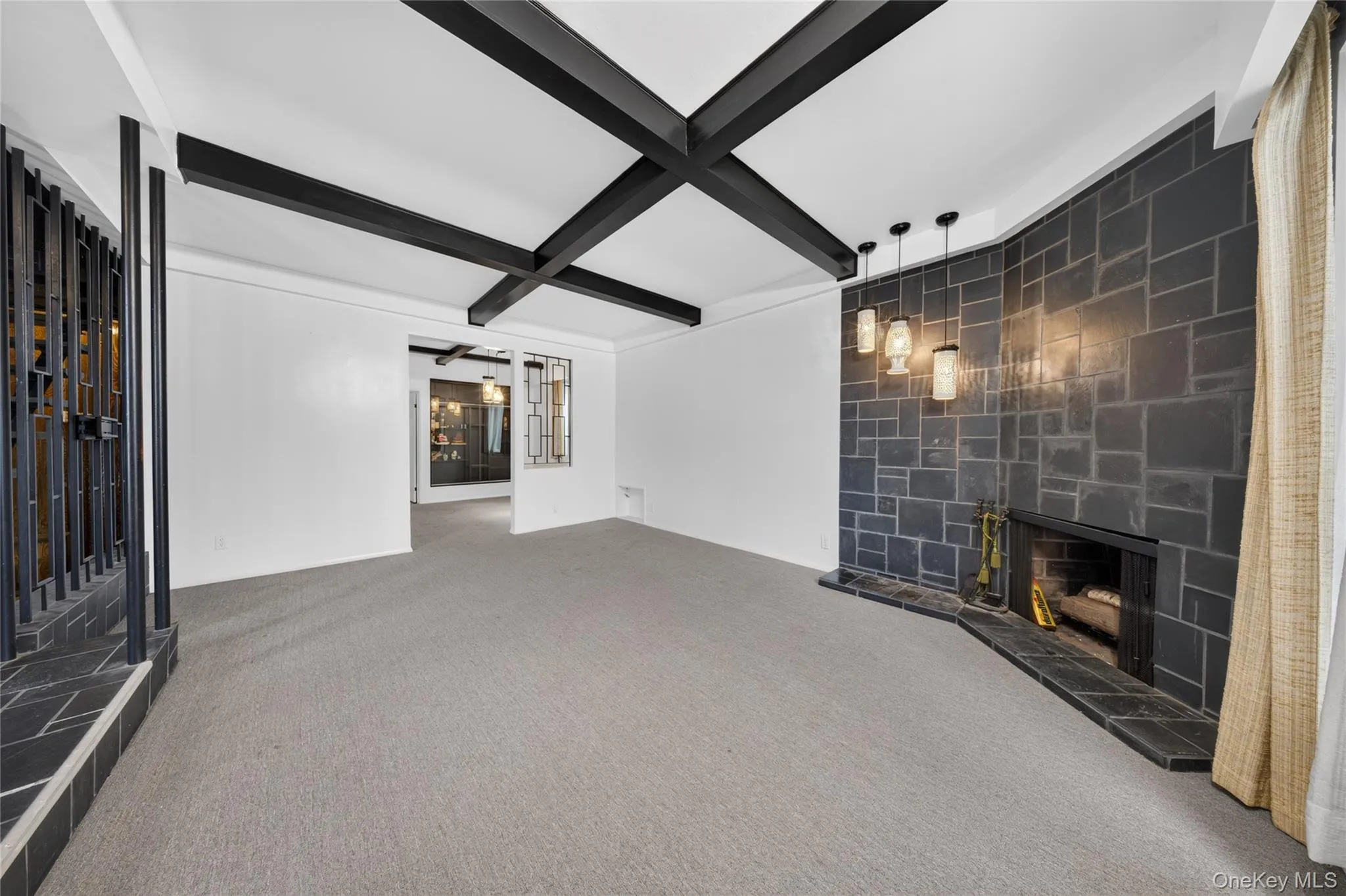 Exposed beam ceiling, tile-surround fireplace, and decorative metalwork accent Exposed beam ceiling, tile-surround fireplace, and decorative metalwork accent
