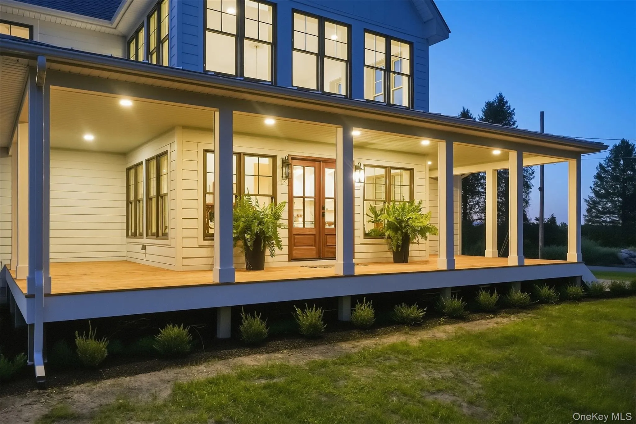True twilight on the wraparound from porch, a dreamy spot to unwind and relax. True twilight on the wraparound from porch, a dreamy spot to unwind and relax.